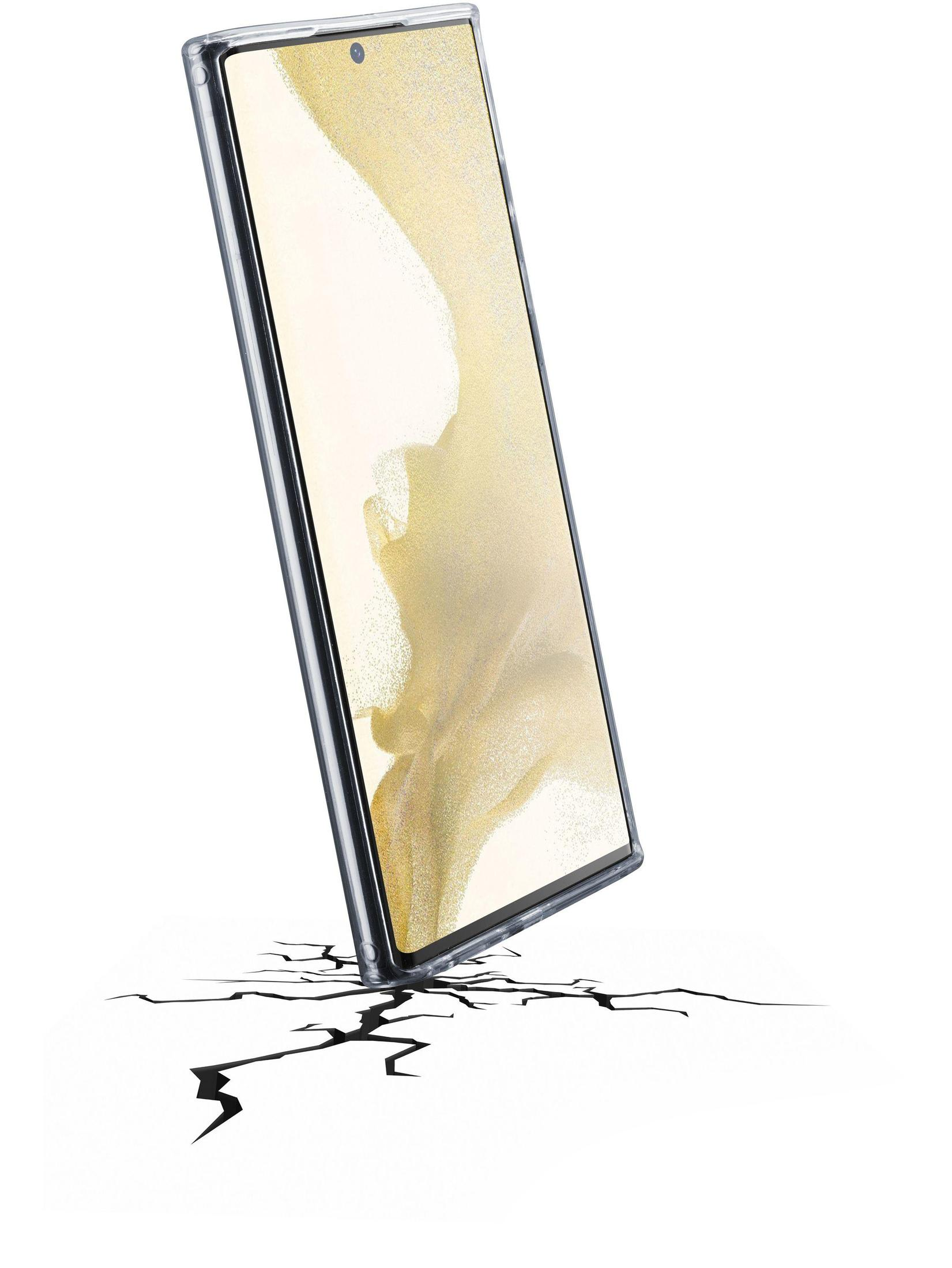 Un smartphone en una funda transparente se apoya en un suelo agrietado, sugiriendo protección contra caídas.