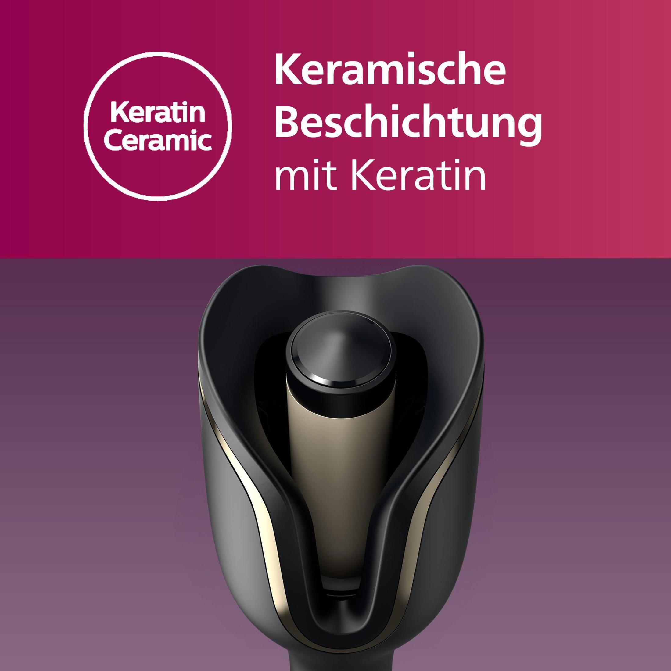 Nahaufnahme eines schwarzen Lockenstabs mit goldfarbenem Akzent. Der Hintergrund ist lila und rot gemischt.
