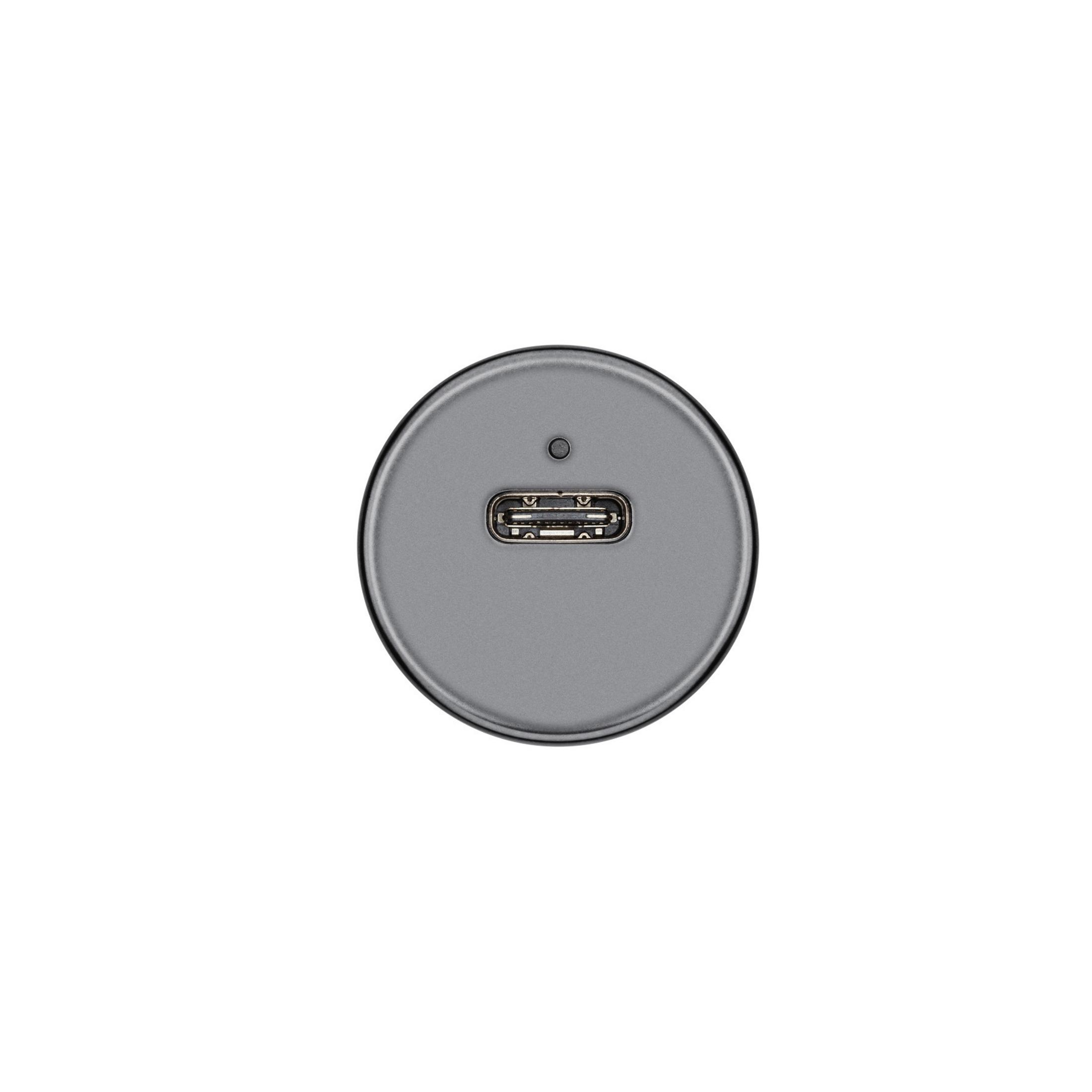 Una porta USB-C grigia su un dispositivo circolare grigio scuro.