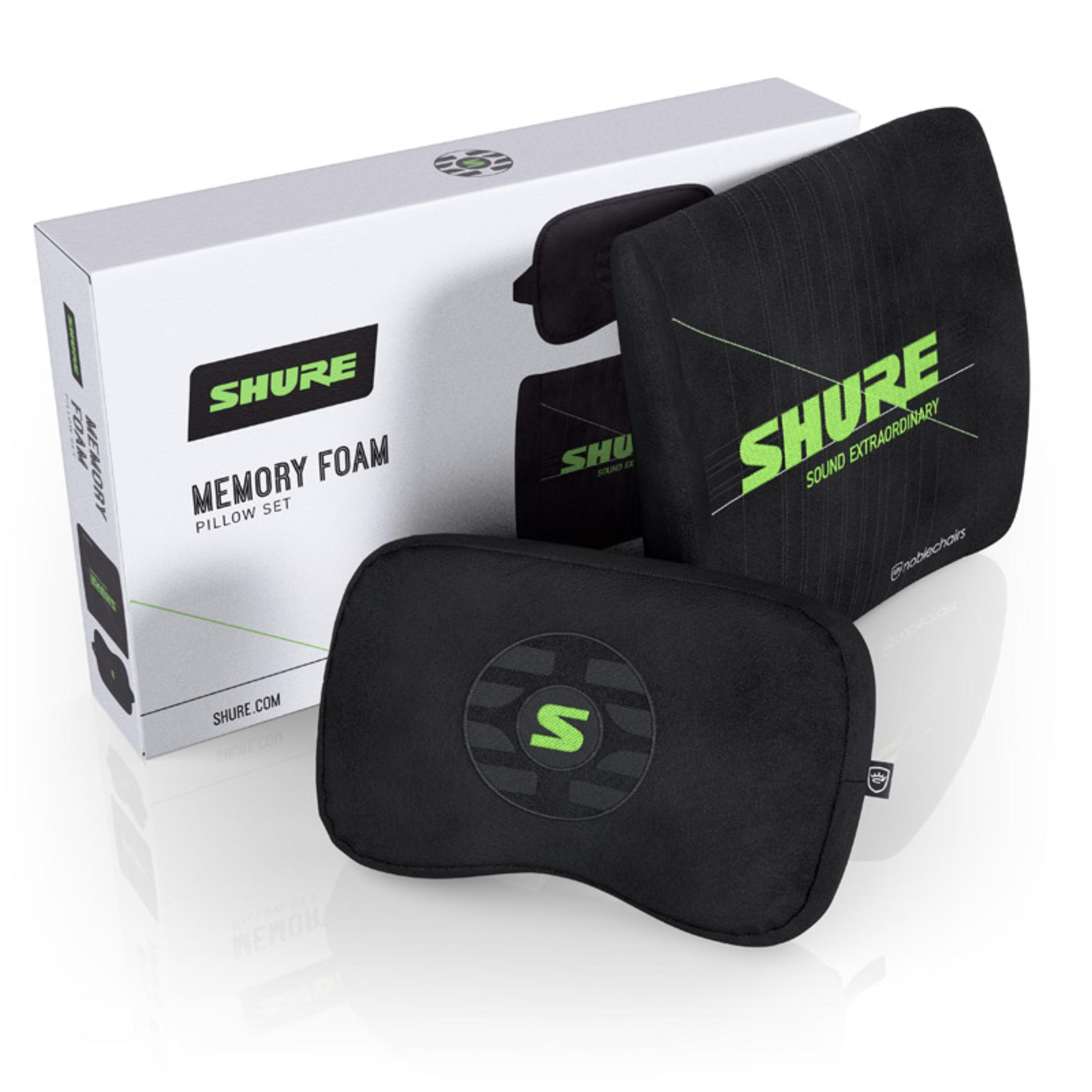 Schwarze Kissen und eine weiße Box. Die Kissen sind schwarz mit grünen Logos. Auf der Box steht 'Memory Foam Pillow Set'.