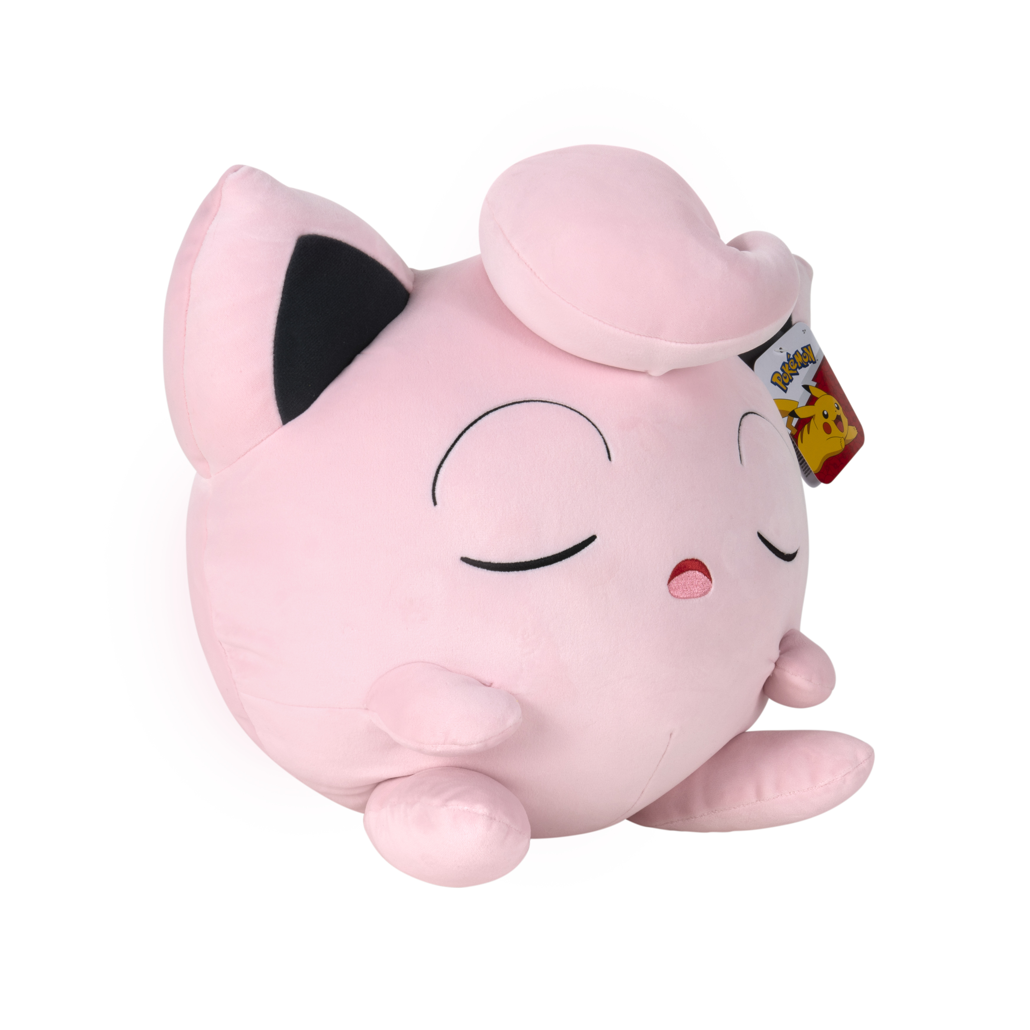 Peluche rose Jigglypuff. Le jouet est rond avec les yeux fermés et une petite bouche.