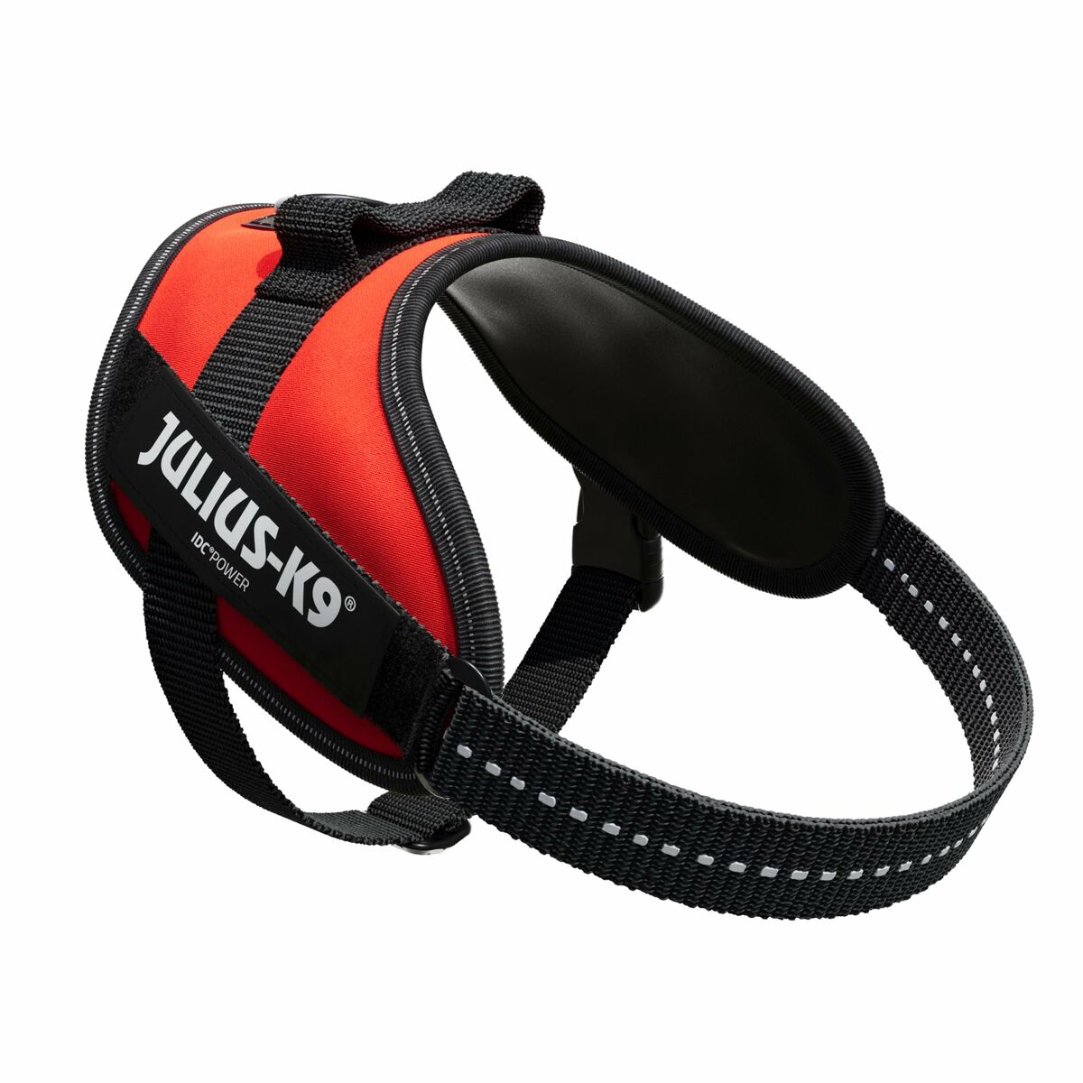 Ein rotes Hunde-Geschirr mit schwarzen Trägern und dem 'Julius-K9'-Logo, isoliert auf weißem Hintergrund.