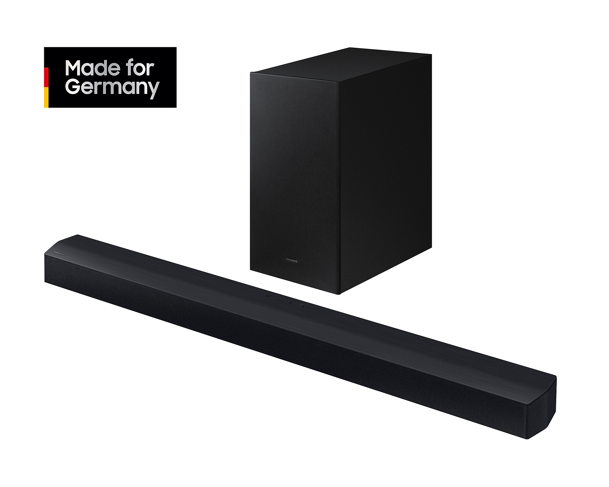 Una barra de sonido negra y un subwoofer. La barra de sonido es larga y rectangular. El texto 'Made for Germany' es visible.