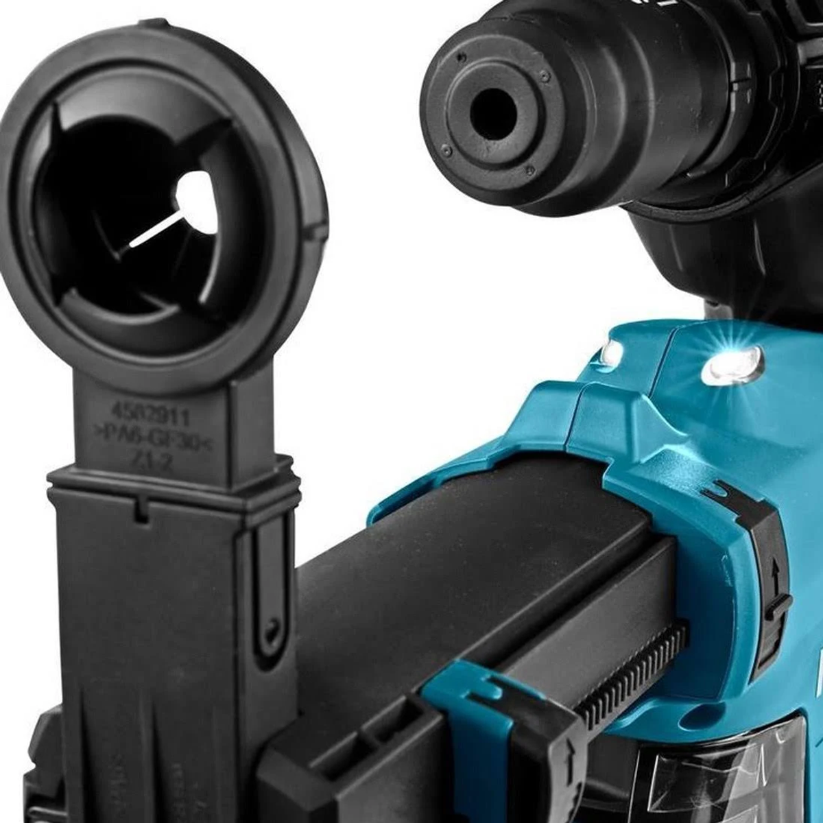 Primer plano de una herramienta Makita. El cuerpo turquesa tiene un mango negro y un accesorio negro. Algunas luces están encendidas.