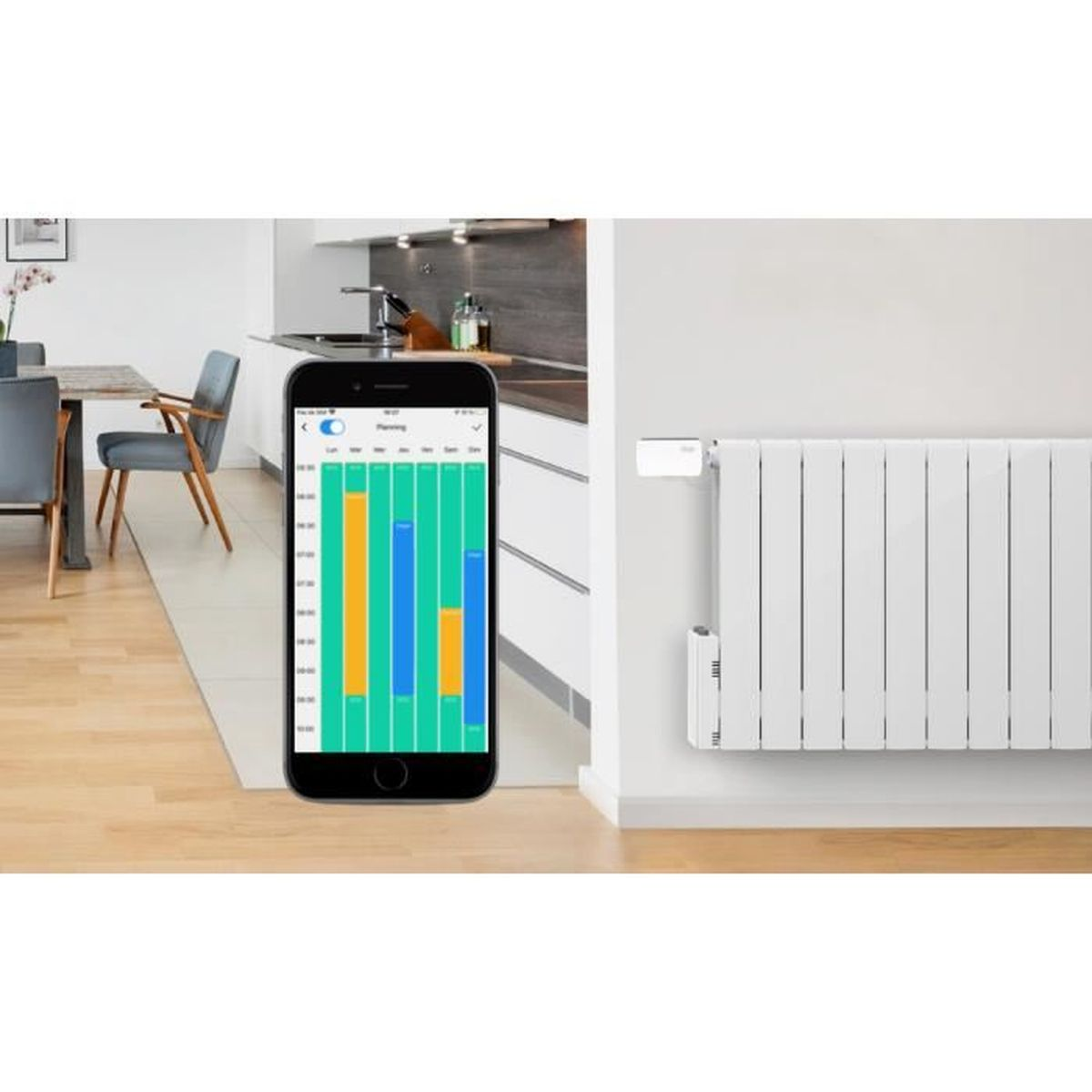 Uno smartphone che mostra un grafico accanto a un radiatore bianco su un muro bianco. Cucina sullo sfondo.