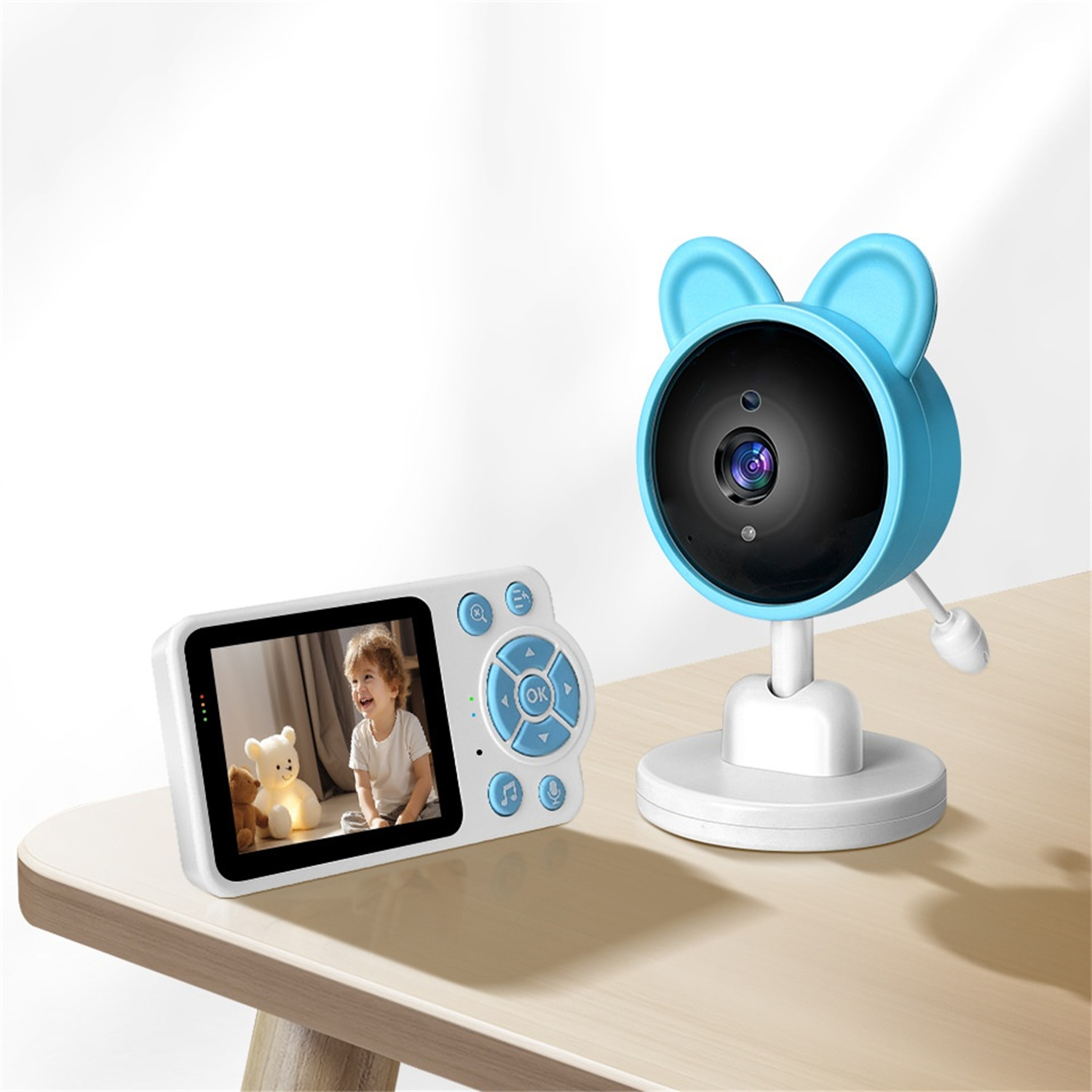 Babyphone mit Bildschirm, der ein Kind zeigt. Blaue Kamera im Hintergrund.