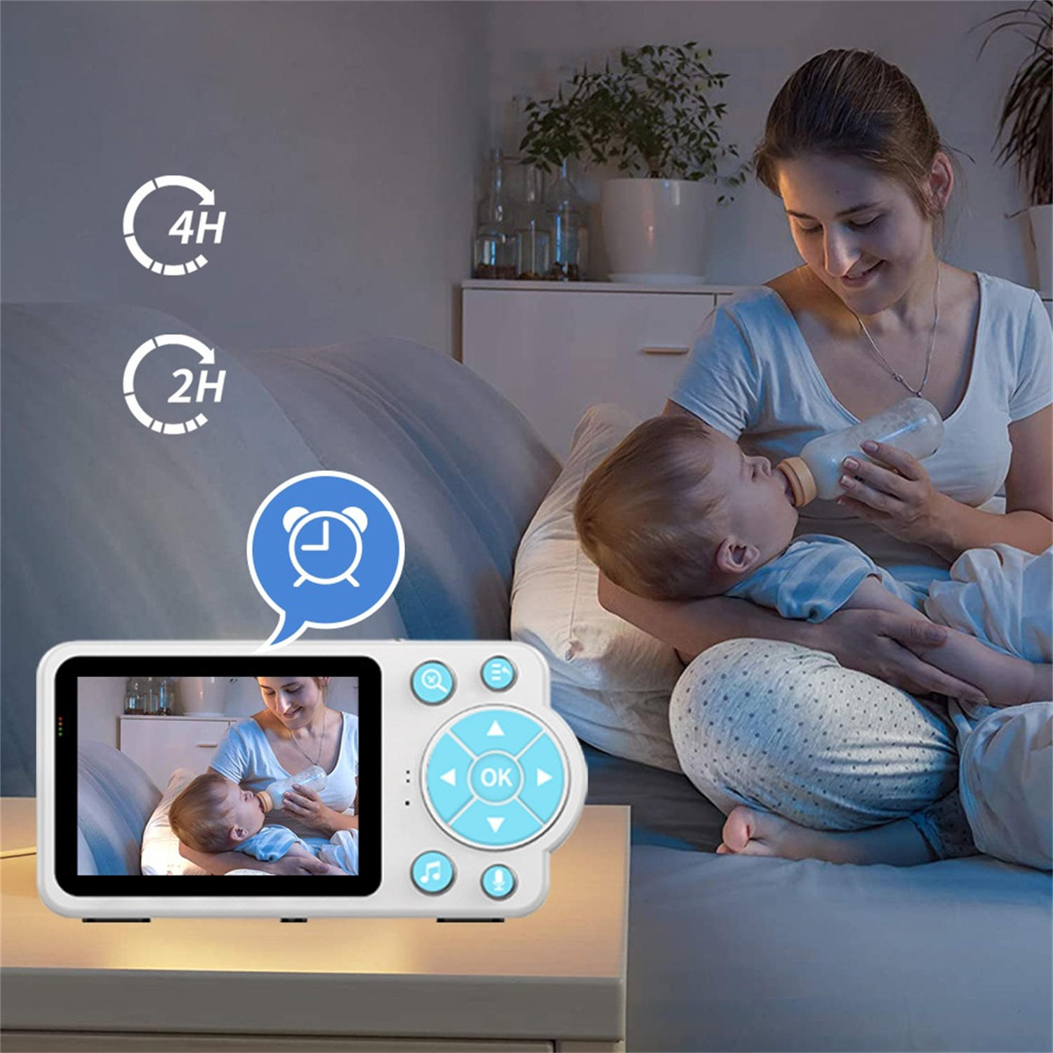 Frau füttert Baby im Bett, mit Babyfon, das die Szene zeigt.