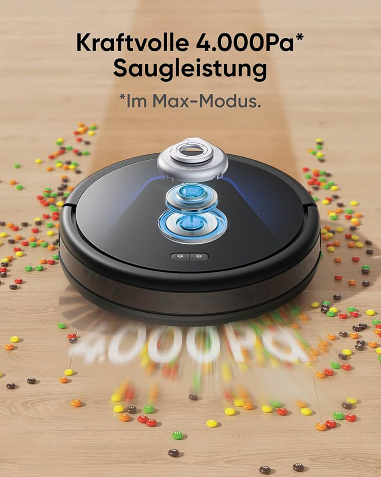 Czarny robot odkurzacz na drewnianej podłodze. Rozrzucone kolorowe cukierki. Tekst '4000Pa'.