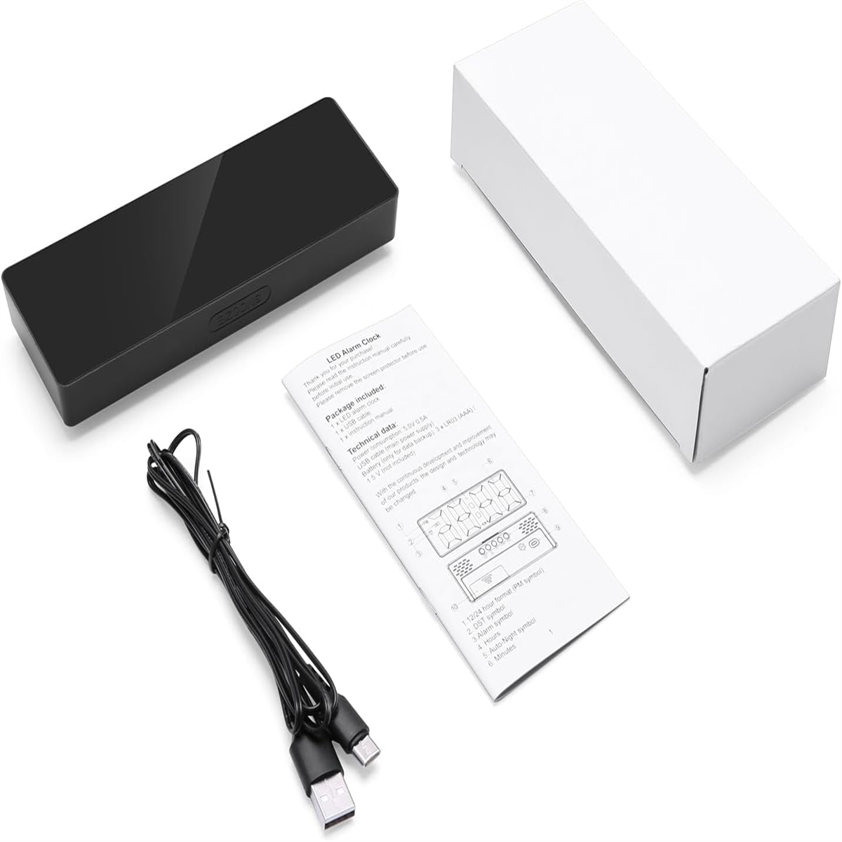LED-Wecker mit schwarzem Gehäuse, USB-Kabel und Bedienungsanleitung.