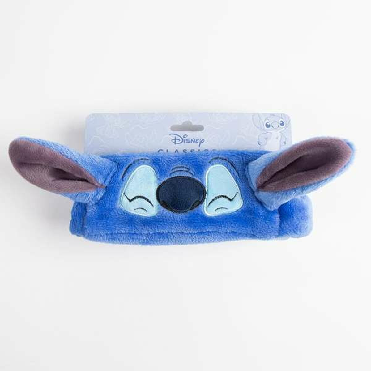 Una fascia blu di Stitch con la faccia del personaggio, su una carta Disney.