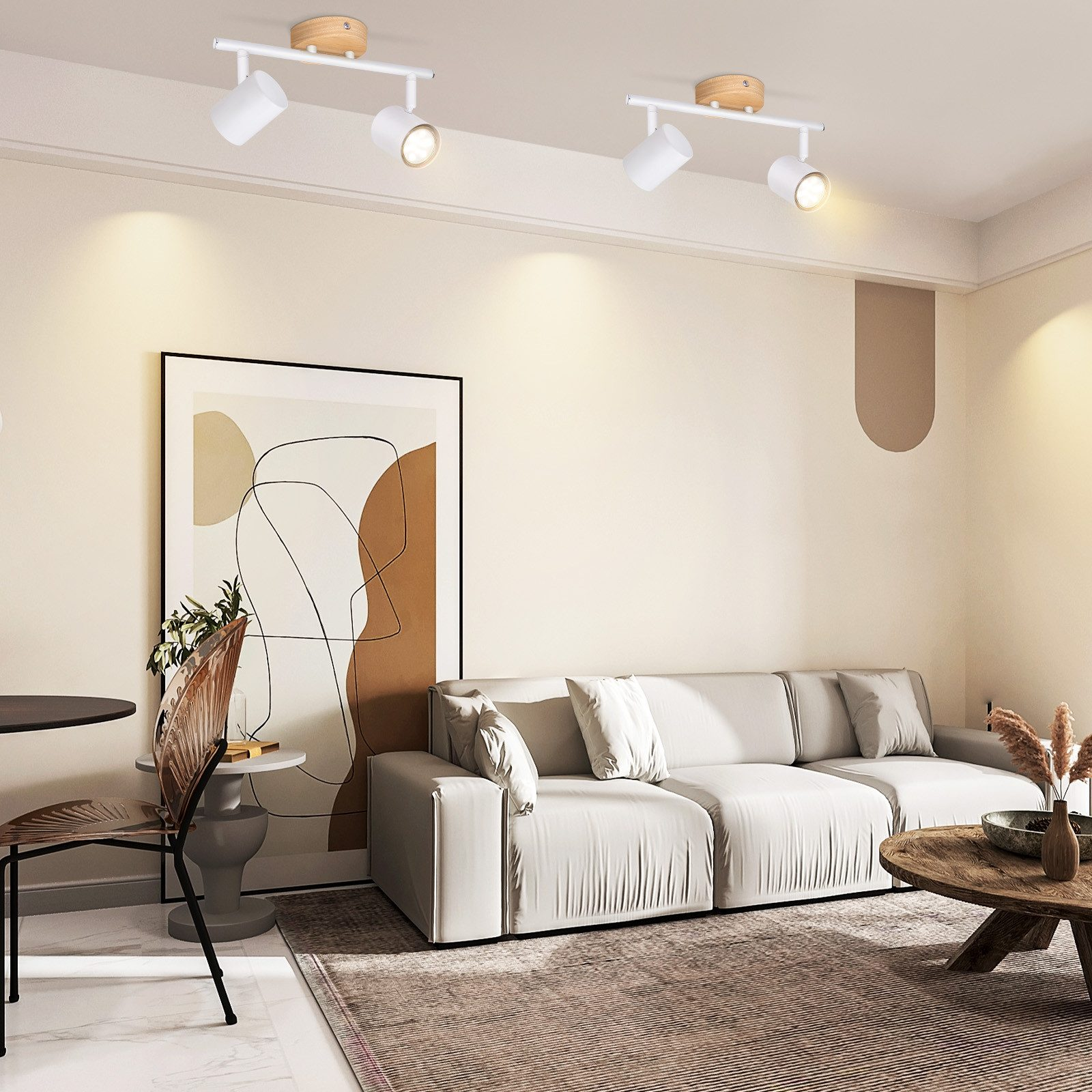 Dwa białe reflektory zamontowane na białej belce. Znajdują się w salonie.