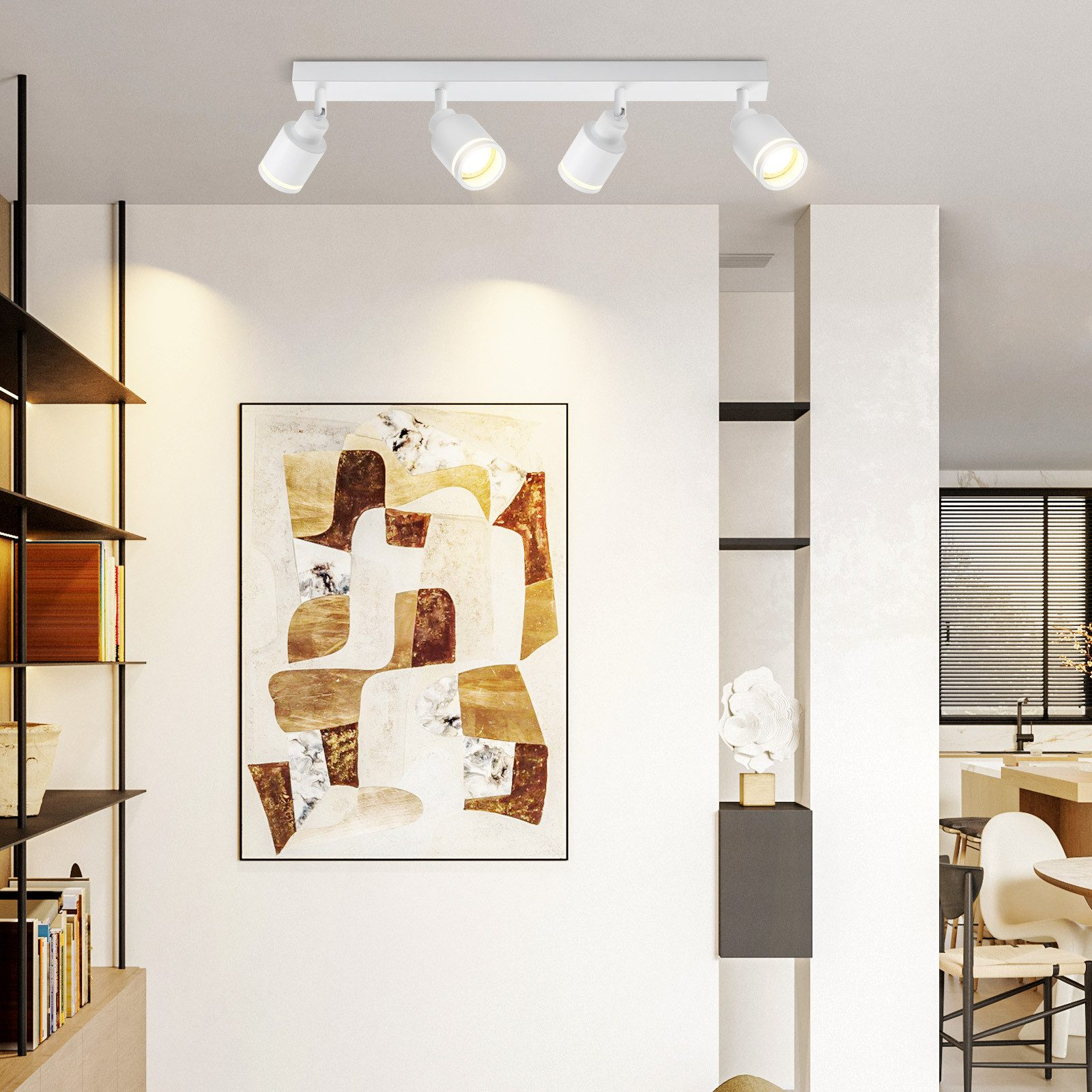 Faretti da soffitto bianchi. Quattro luci su una guida, illuminano una parete bianca con arte.