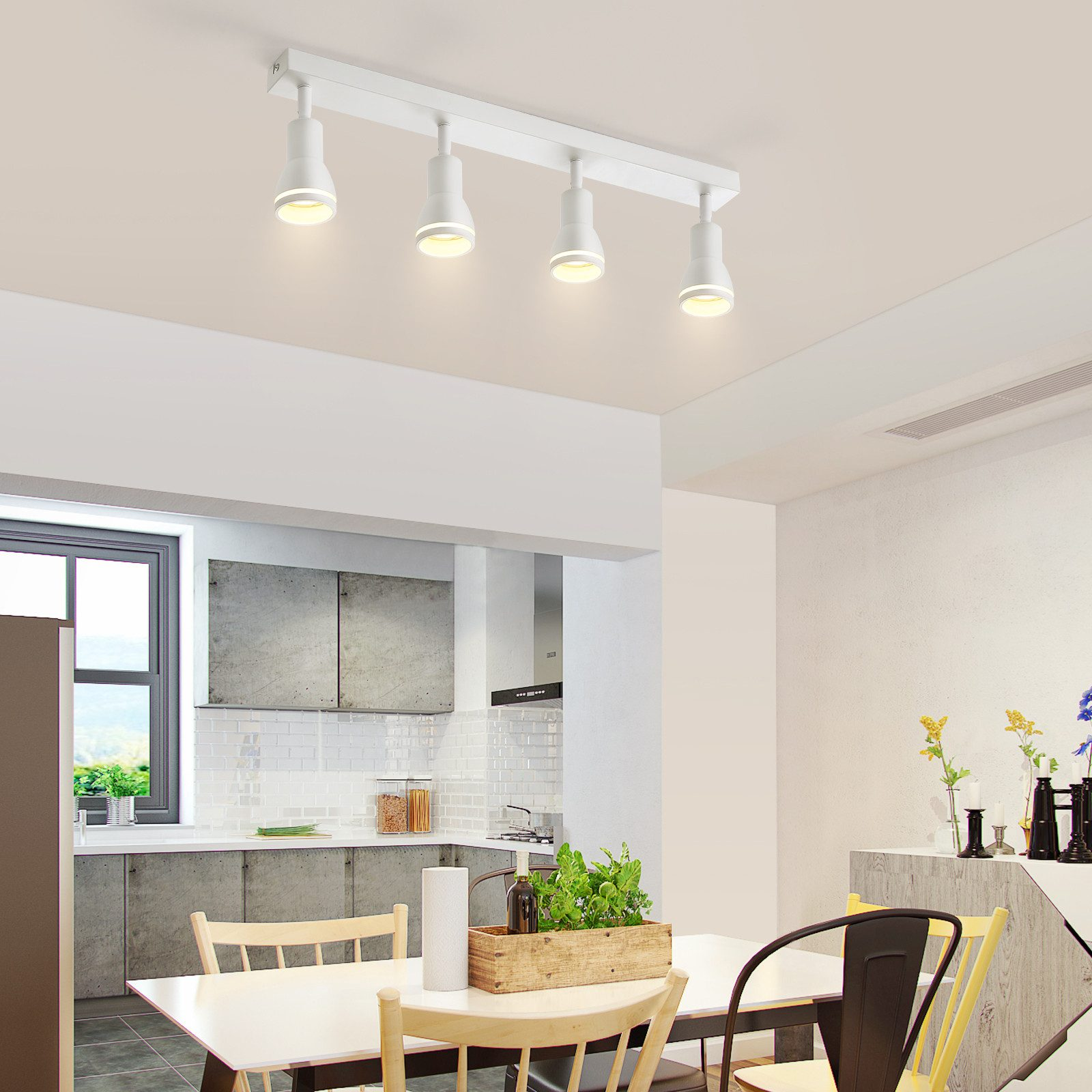 Luci a soffitto bianche, quattro faretti orientabili su sfondo bianco.