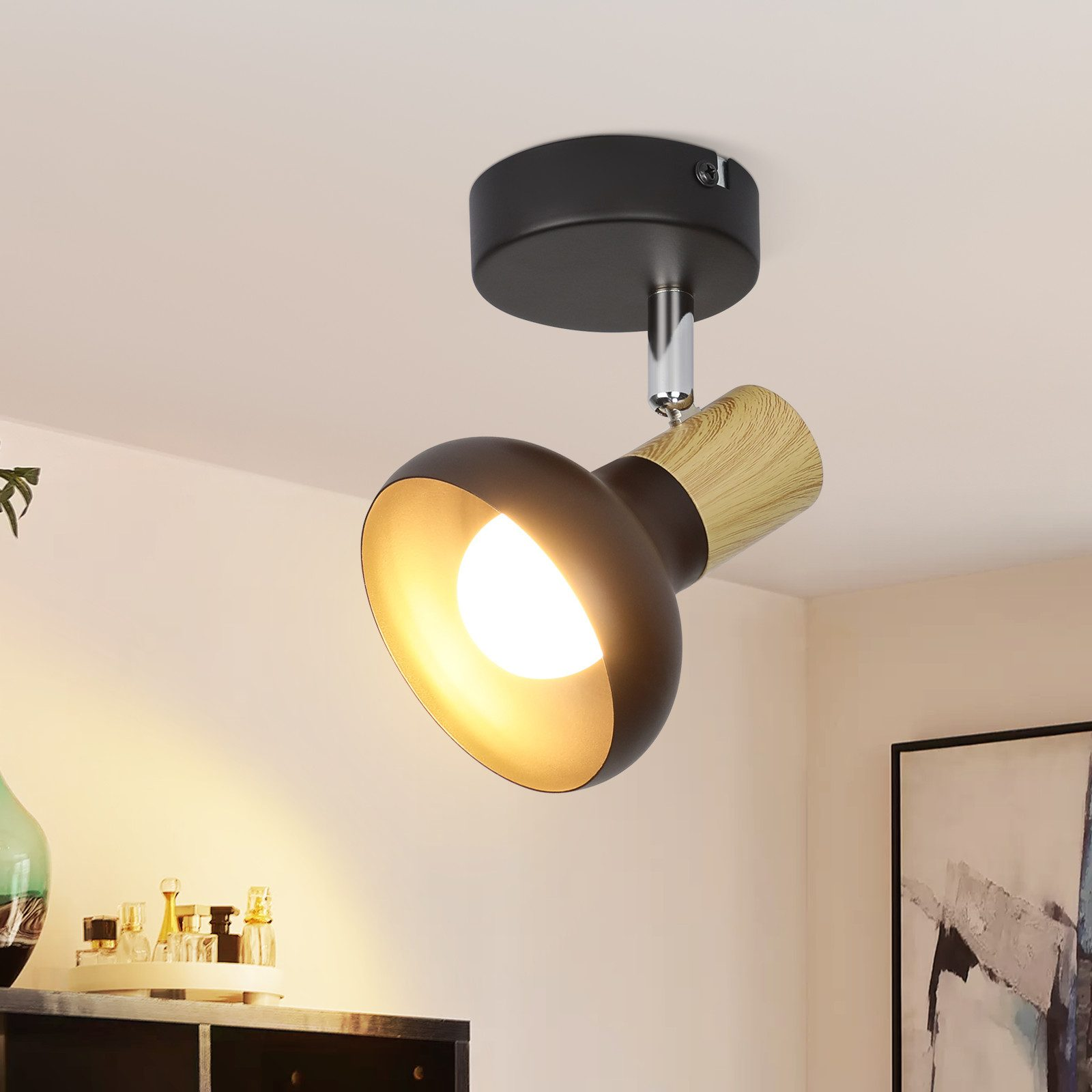 Faretto nero e legno montato su un soffitto bianco, con una lampadina.