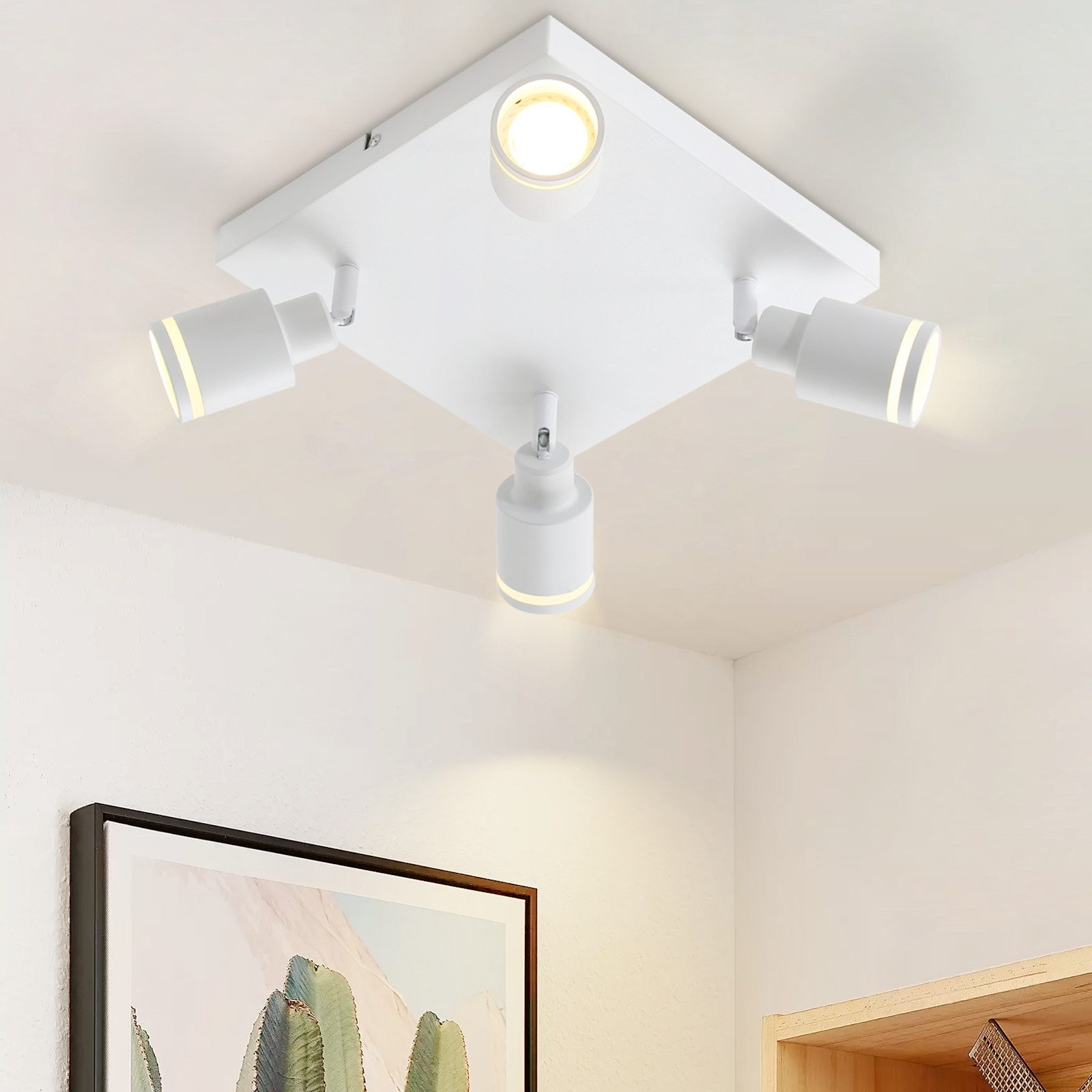 Plafoniera bianca con tre faretti orientabili. Soffitto e pareti bianche.