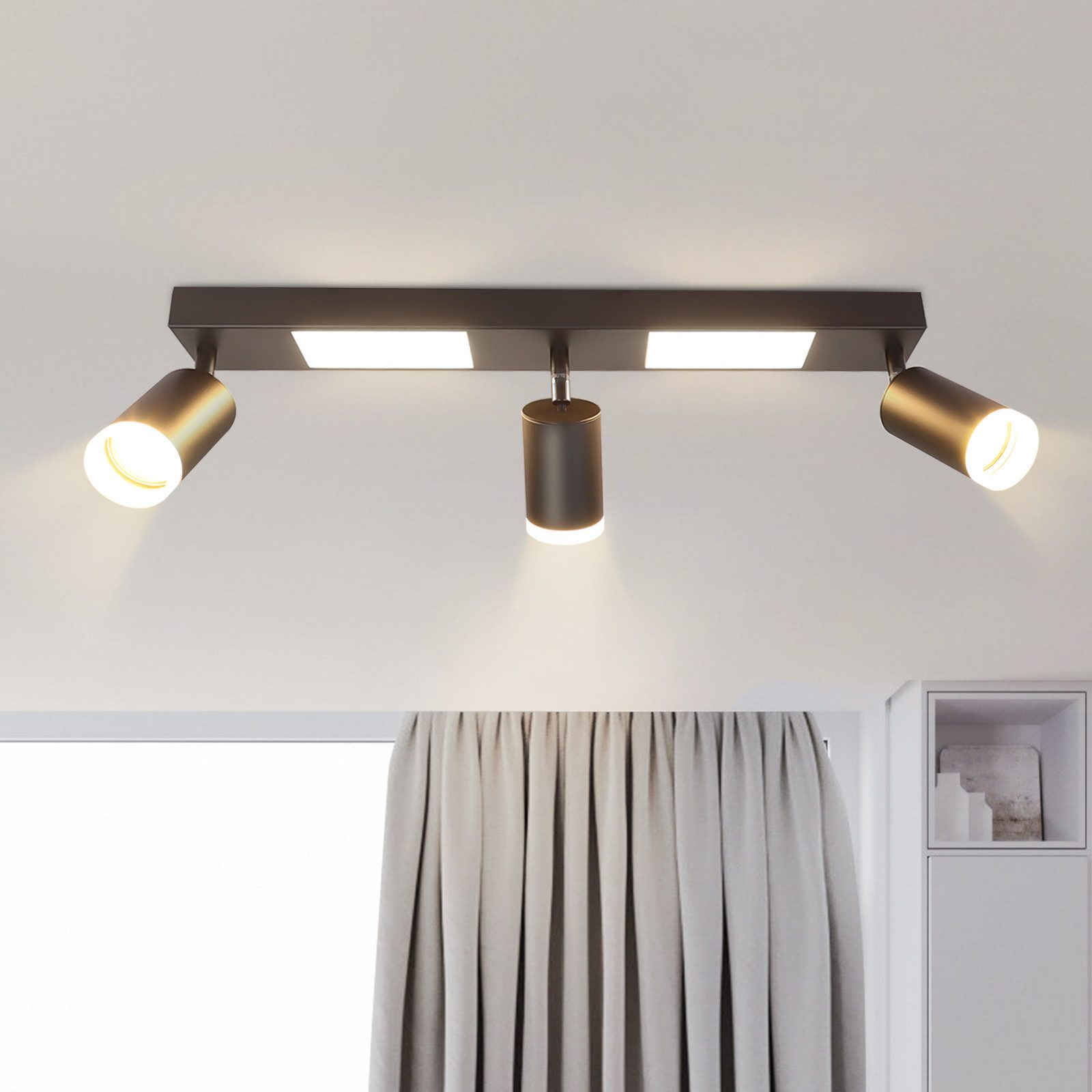 Una plafoniera con tre faretti, due pannelli luminosi bianchi e un soffitto bianco.