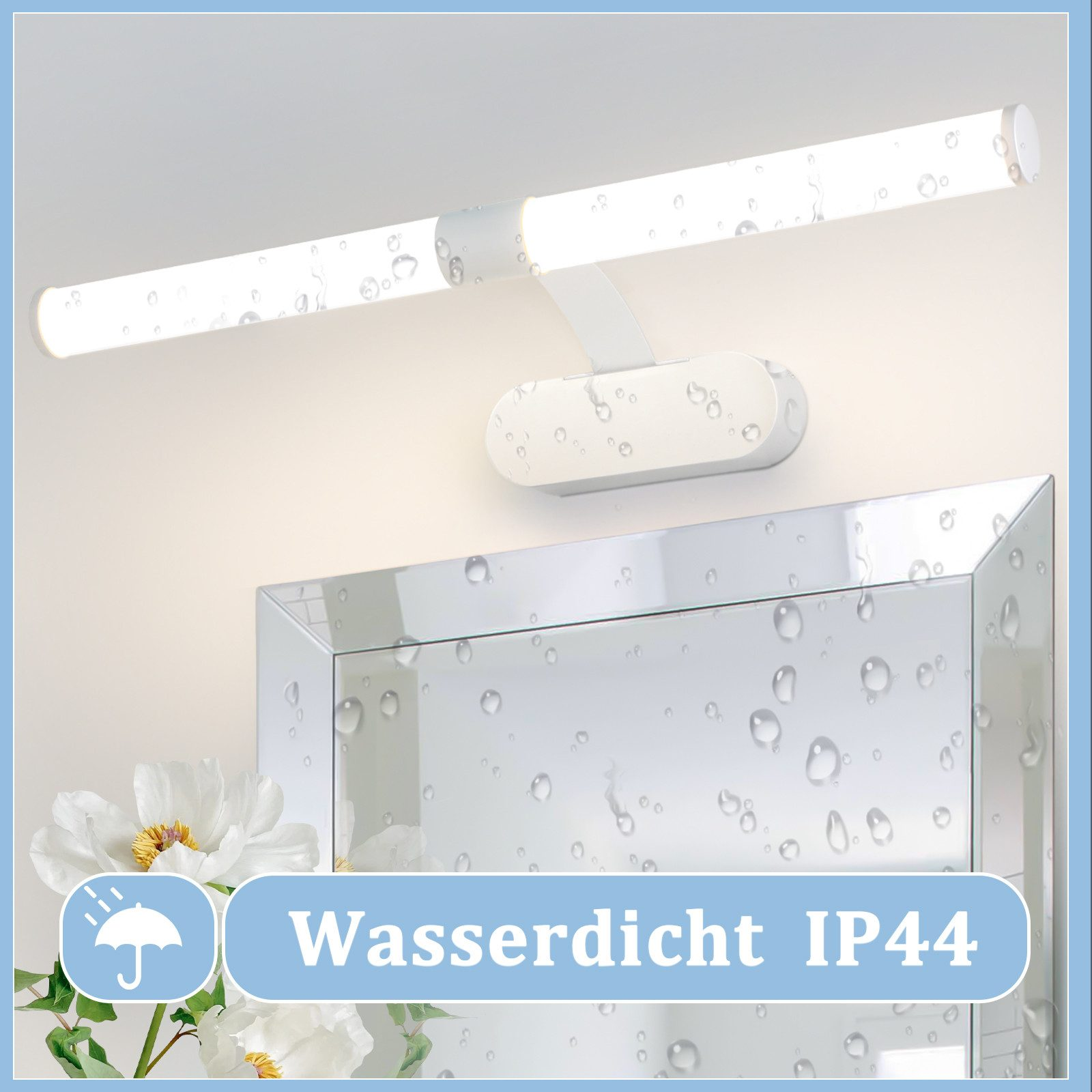 Apparecchio di illuminazione a LED bianco impermeabile IP44 sopra uno specchio con gocce d'acqua. Fiori bianchi in primo piano.
