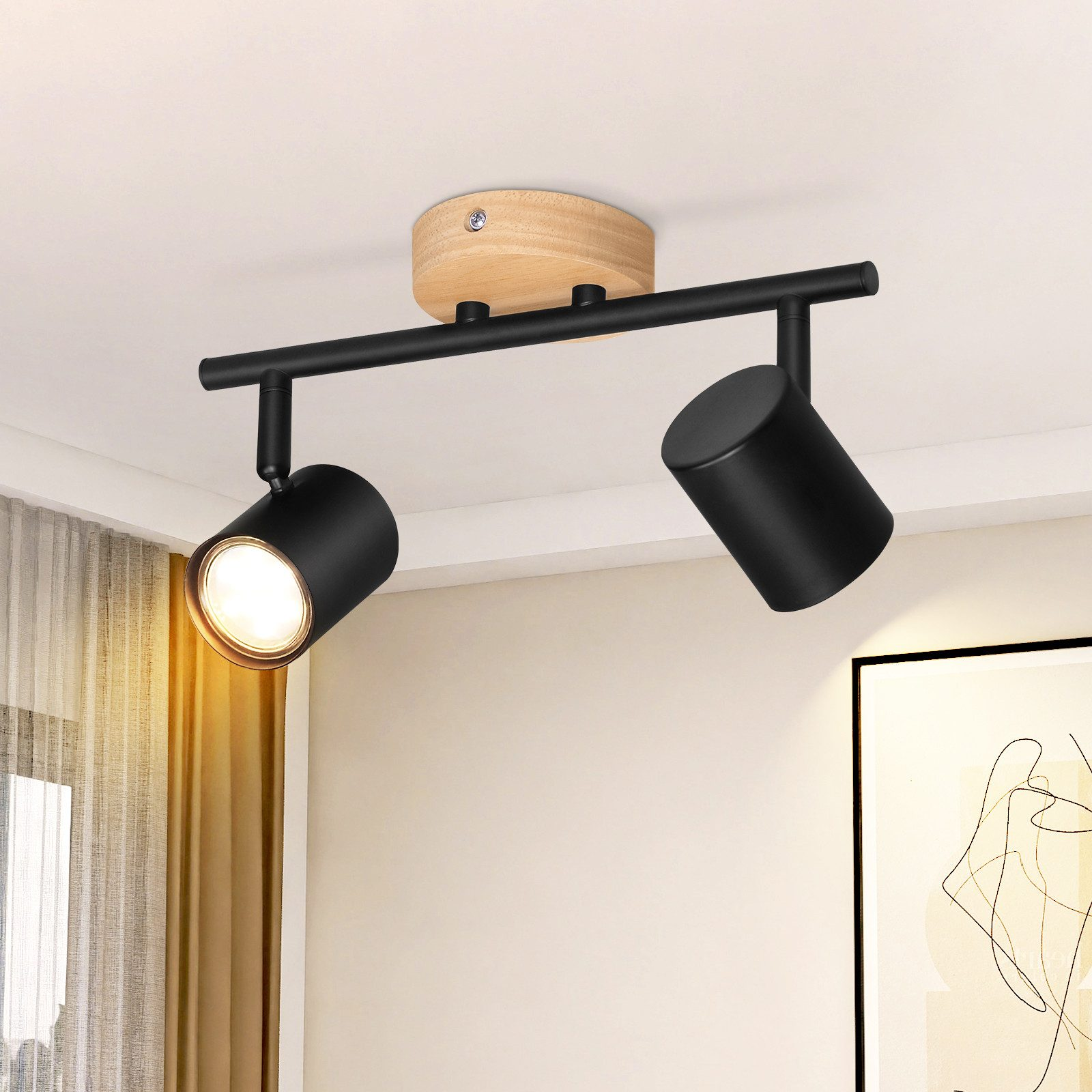 Un soffitto con un apparecchio a faretti nero con due luci regolabili, su un soffitto neutro.
