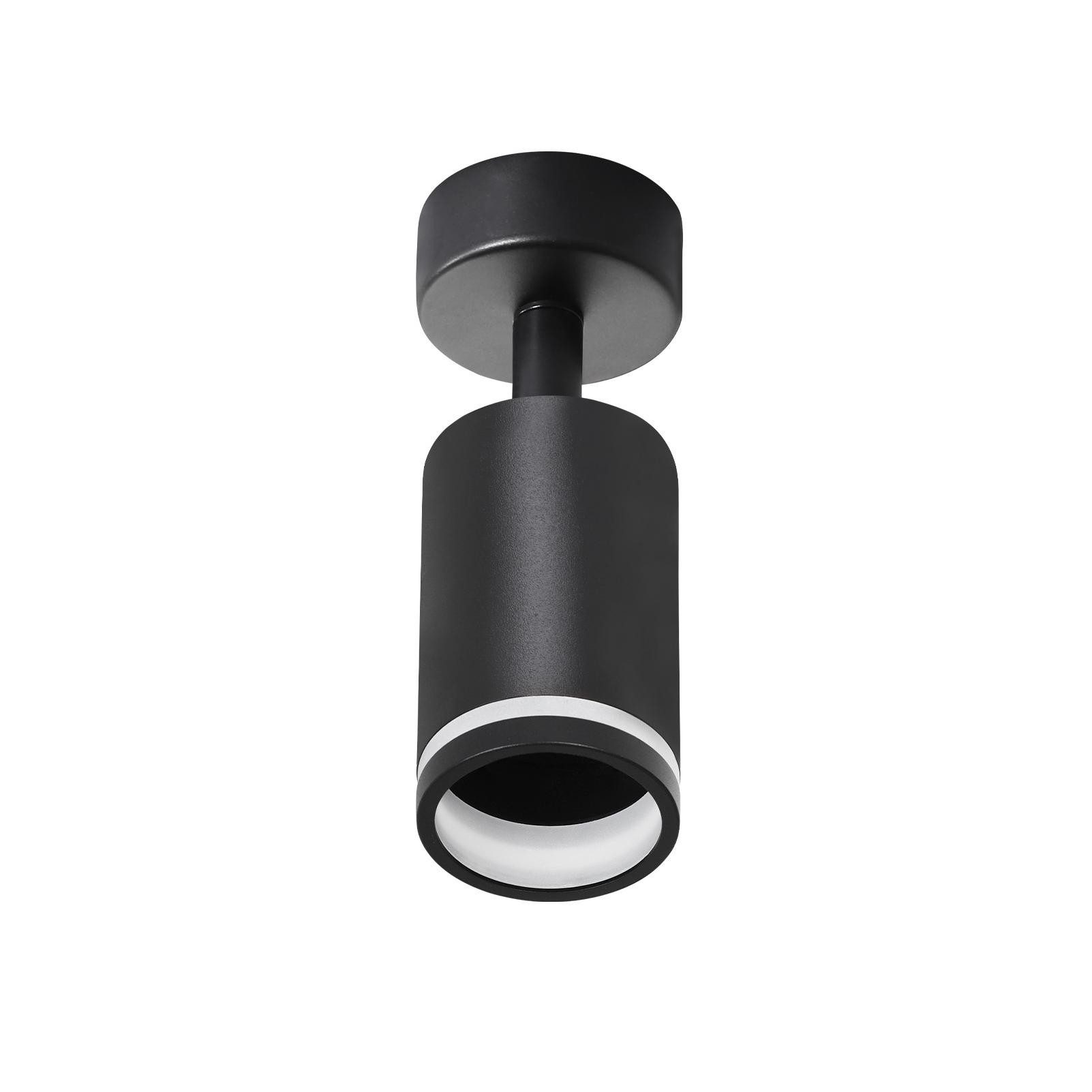 Lampada cilindrica nera con anello bianco, fissata a una base nera rotonda.