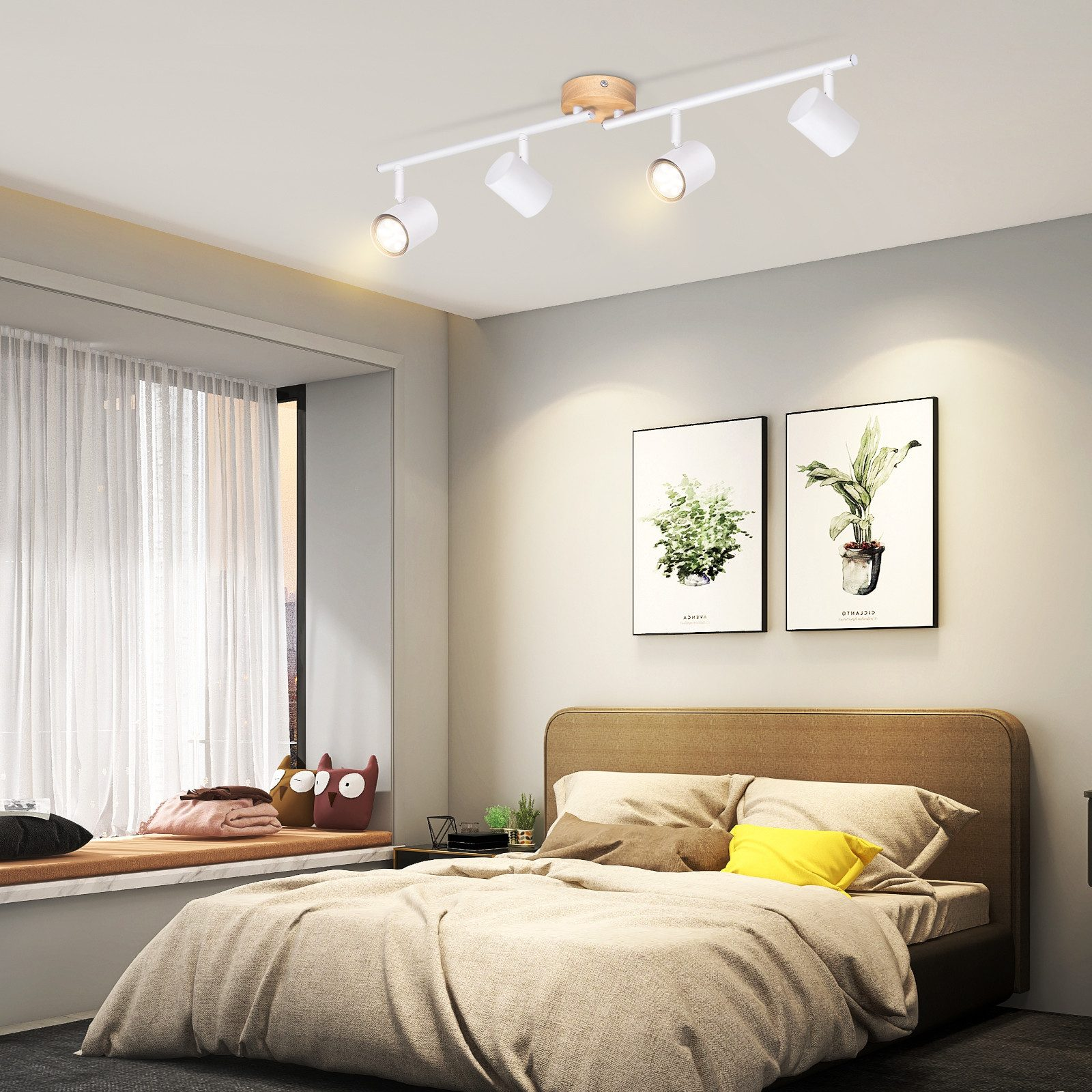 Sypialnia z łóżkiem i dwoma obrazami. Sufit ma cztery białe reflektory i drewnianą belkę.