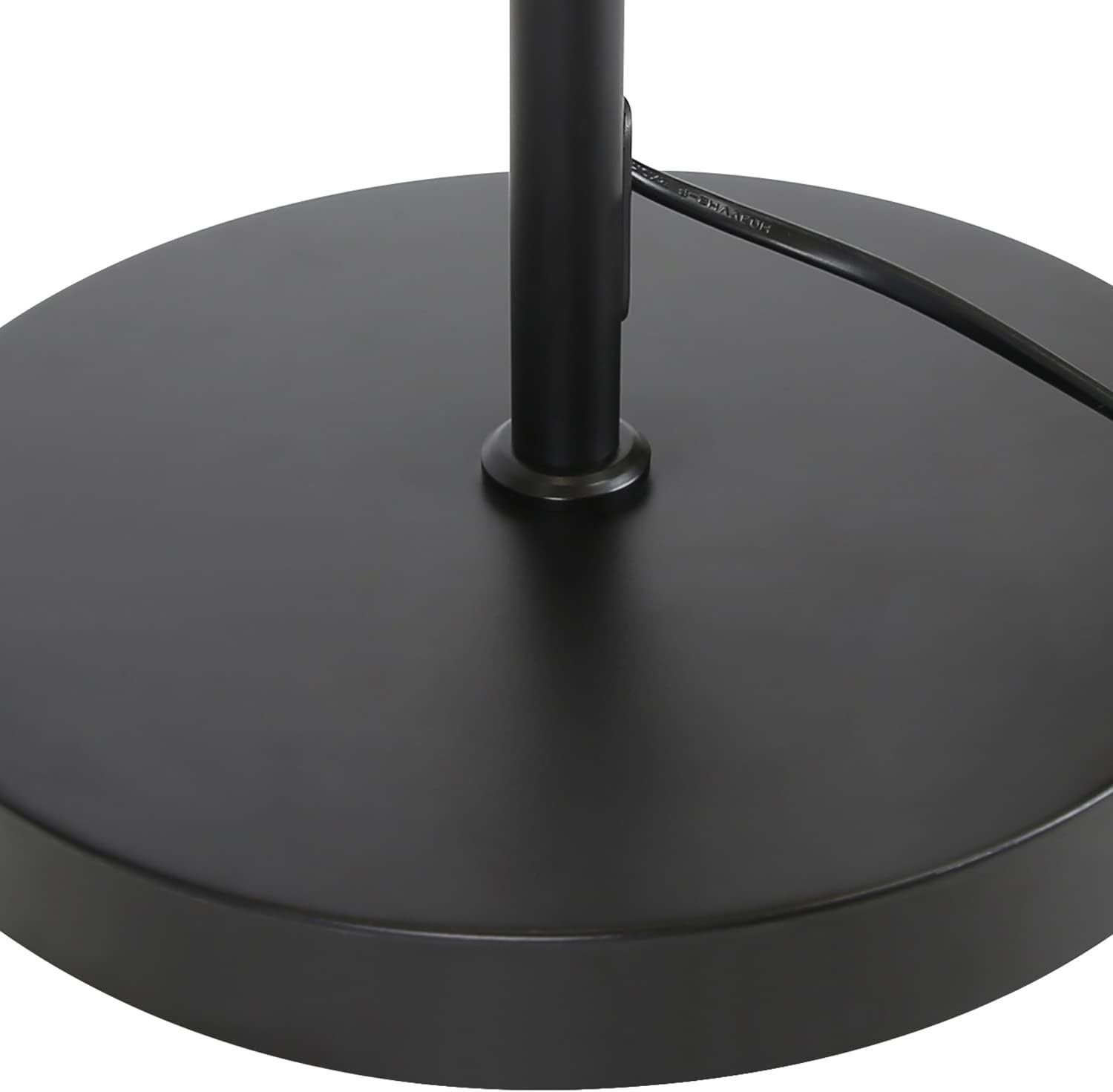 Una base per lampada nera e circolare con un cavo che esce dall'alto.