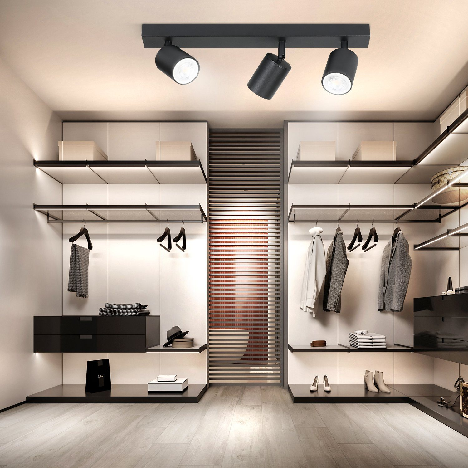 Interno guardaroba con tre faretti neri montati su un binario nero. Design moderno.
