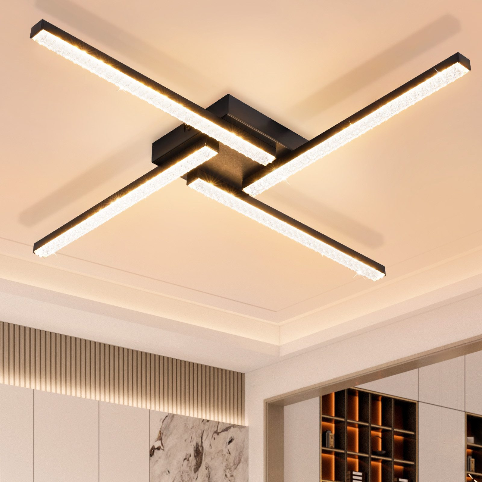 Una plafoniera nera con quattro barre luminose orizzontali e luminose disposte a forma di croce.