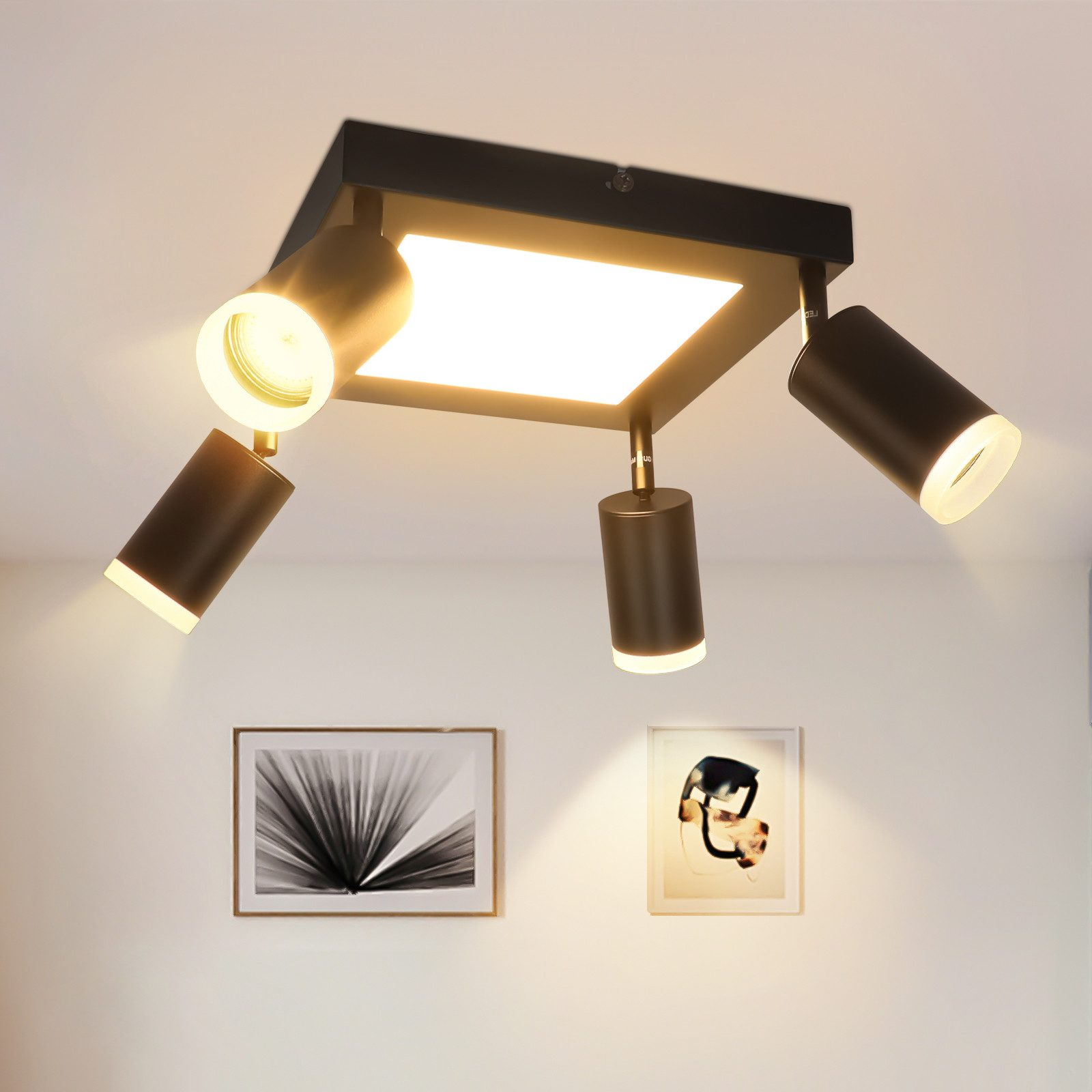 Czarna lampa sufitowa z trzema reflektorami i centralnym kwadratowym światłem, oświetlająca pomieszczenie.