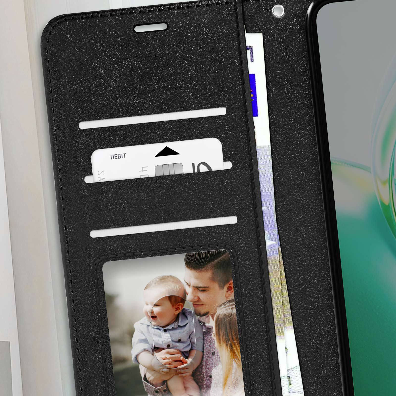 Portafoglio nero con carta di debito, contanti e una foto di un uomo sorridente che tiene un bambino.