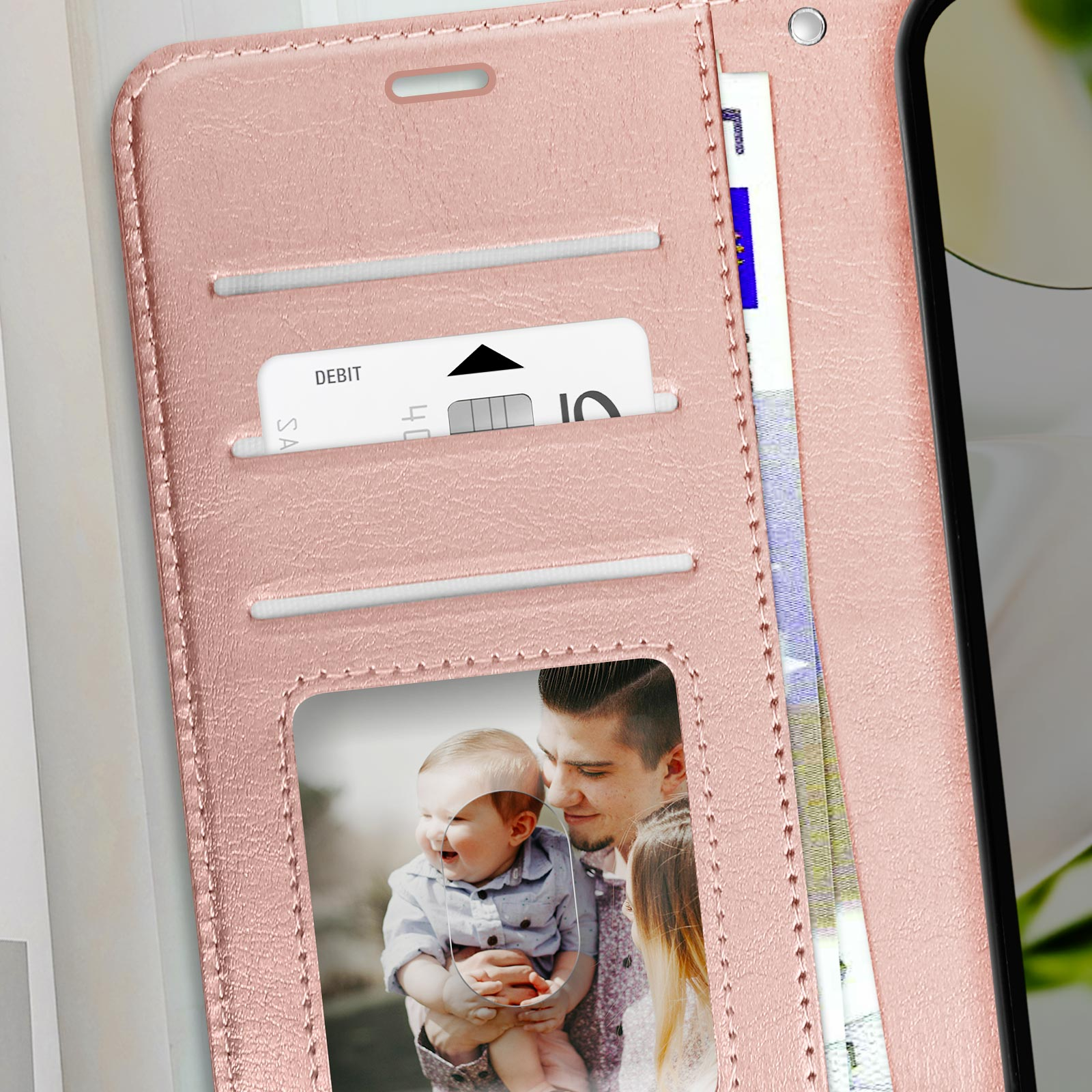 Rosa Handyhülle mit Kartenfächern, einem lächelnden Babyfoto und einem Mann, der das Baby hält.