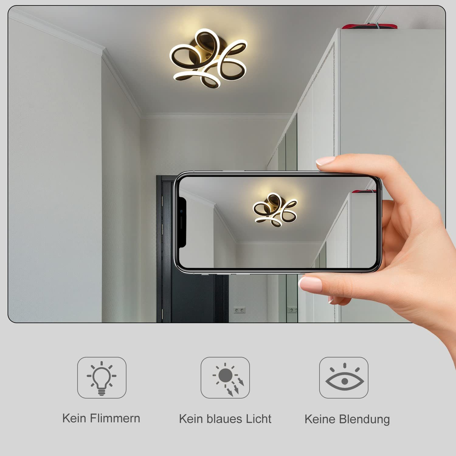 Una persona tiene in mano un telefono che mostra una luce a soffitto. La luce è un design floreale stilizzato, oro e bianco.