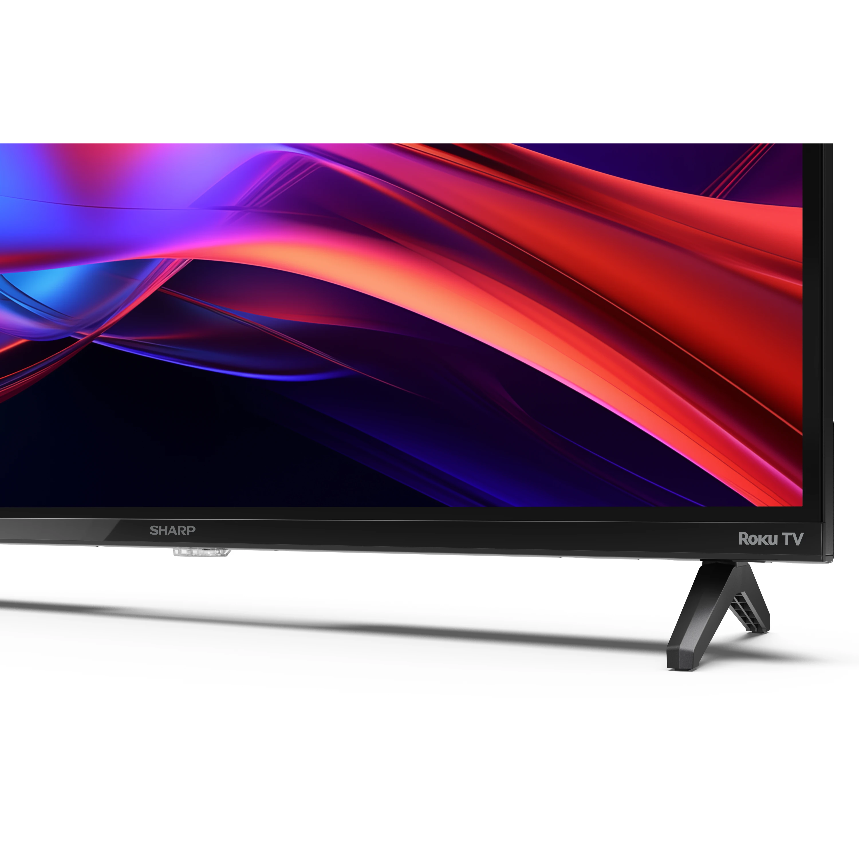 Sharp Roku TV. Schwarzer Rahmen und Ständer. Display zeigt bunte, abstrakte Formen.