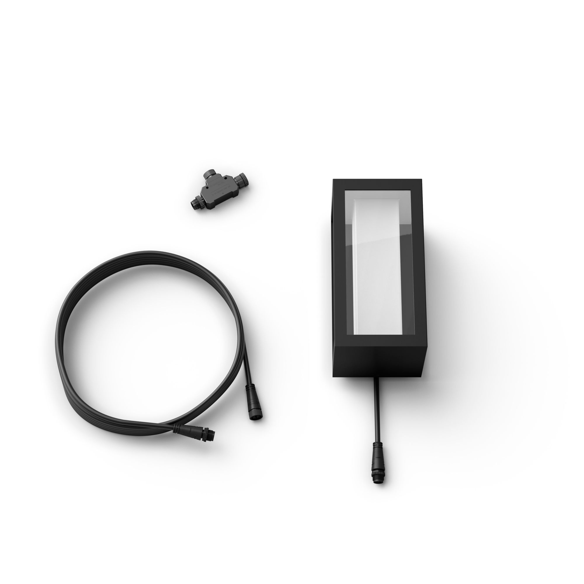 Schwarze rechteckige Leuchte und Zubehör auf weißer Oberfläche. Schwarze Kabel und Stecker.