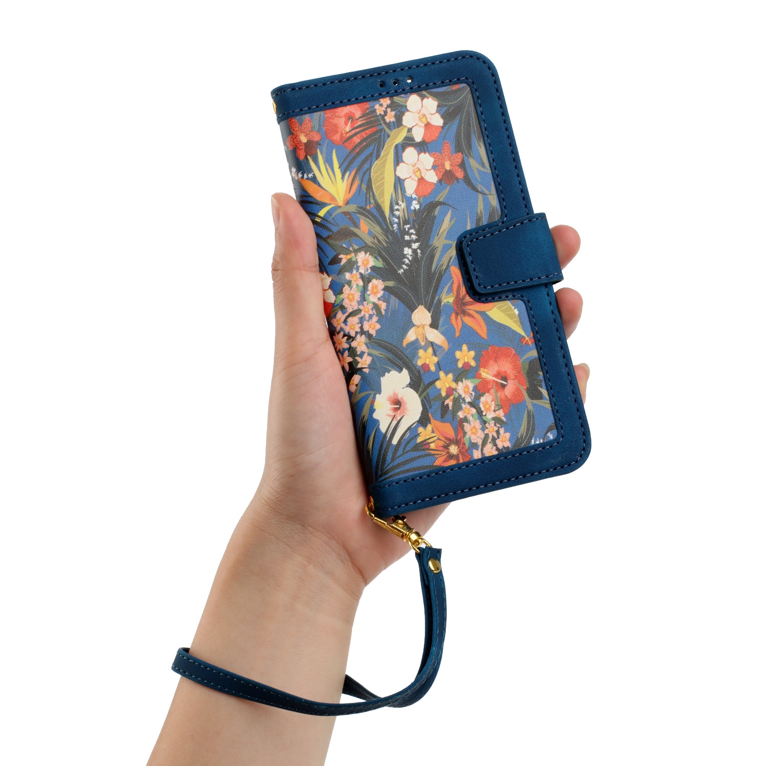 Una mano sosteniendo una funda azul para teléfono con un diseño floral. Tiene una correa de muñeca.