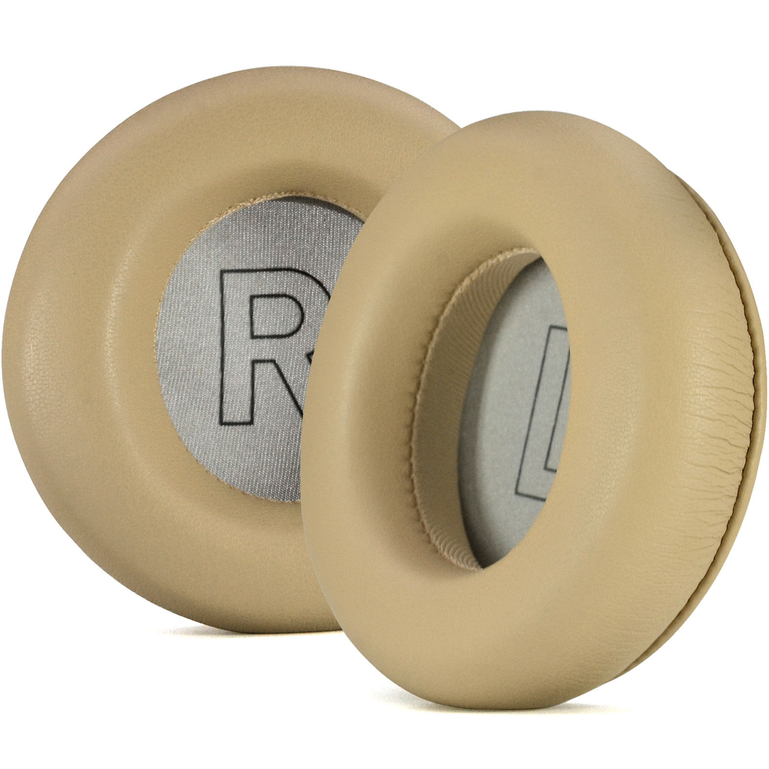 Dwie beżowe wkładki do słuchawek, z literą 'R' i widocznym logo.