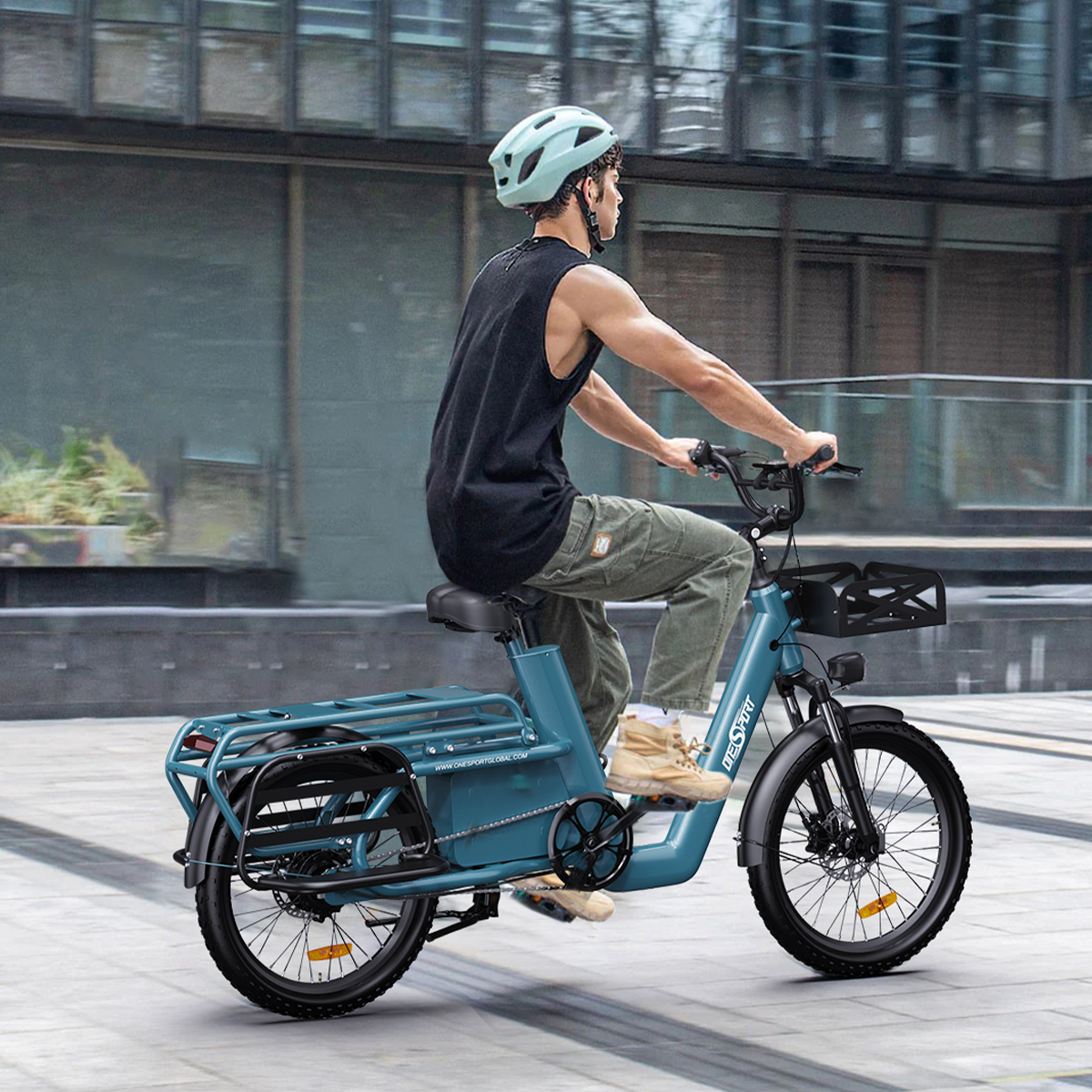 Mężczyzna jedzie turkusowym rowerem elektrycznym po utwardzonej ścieżce. Ma kask i czarną koszulę.