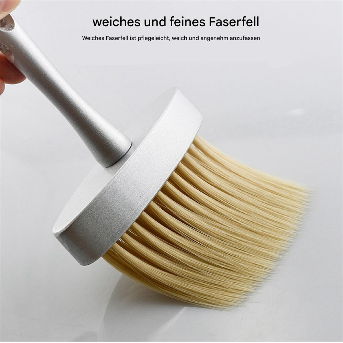 Eine silberne Bürste mit hellbraunen Borsten, gehalten von einer Hand. Oben steht: 'weiches und feines Faserfell'.