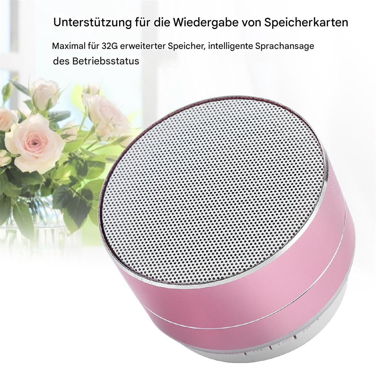 Ein rosa-silberner tragbarer Lautsprecher mit weißem Hintergrund, und Blumen sind sichtbar.