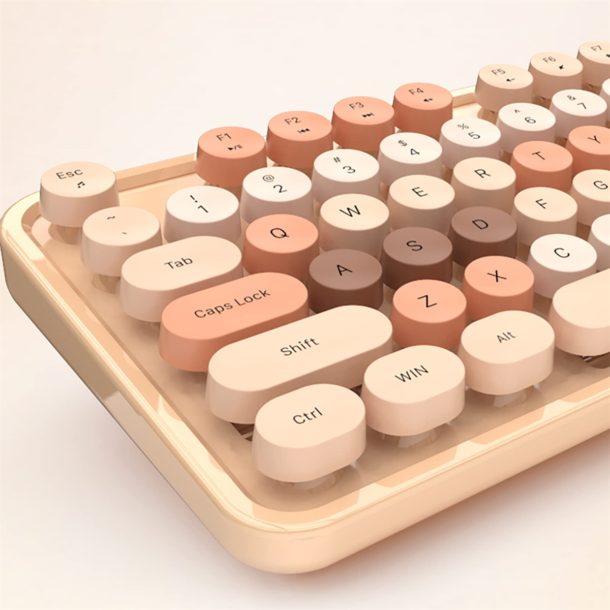 Eine Tastatur im Retro-Stil mit runden Tasten in Beige- und Brauntönen mit beigem Sockel.