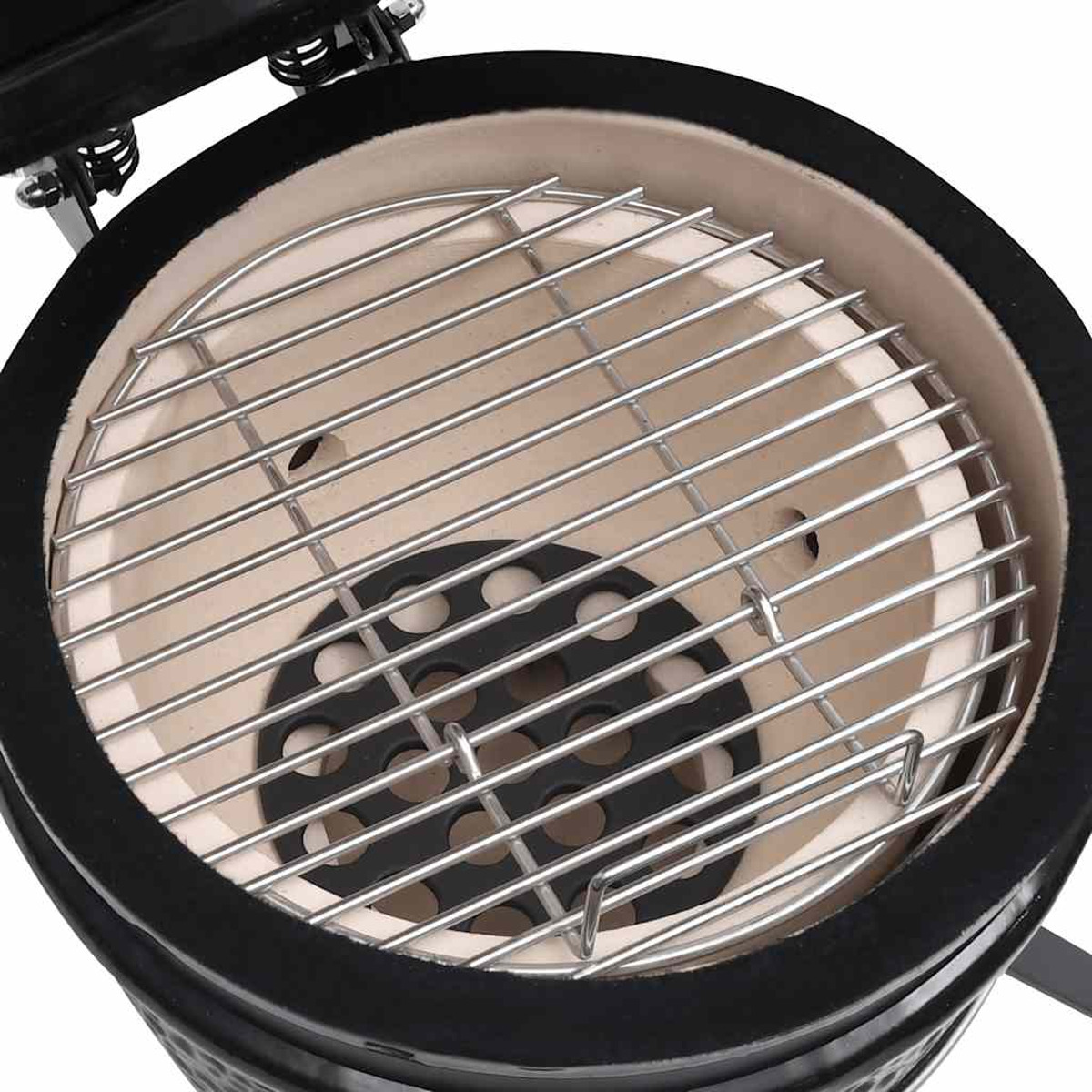 Interno del grill in ceramica con griglia metallica e base nera.
