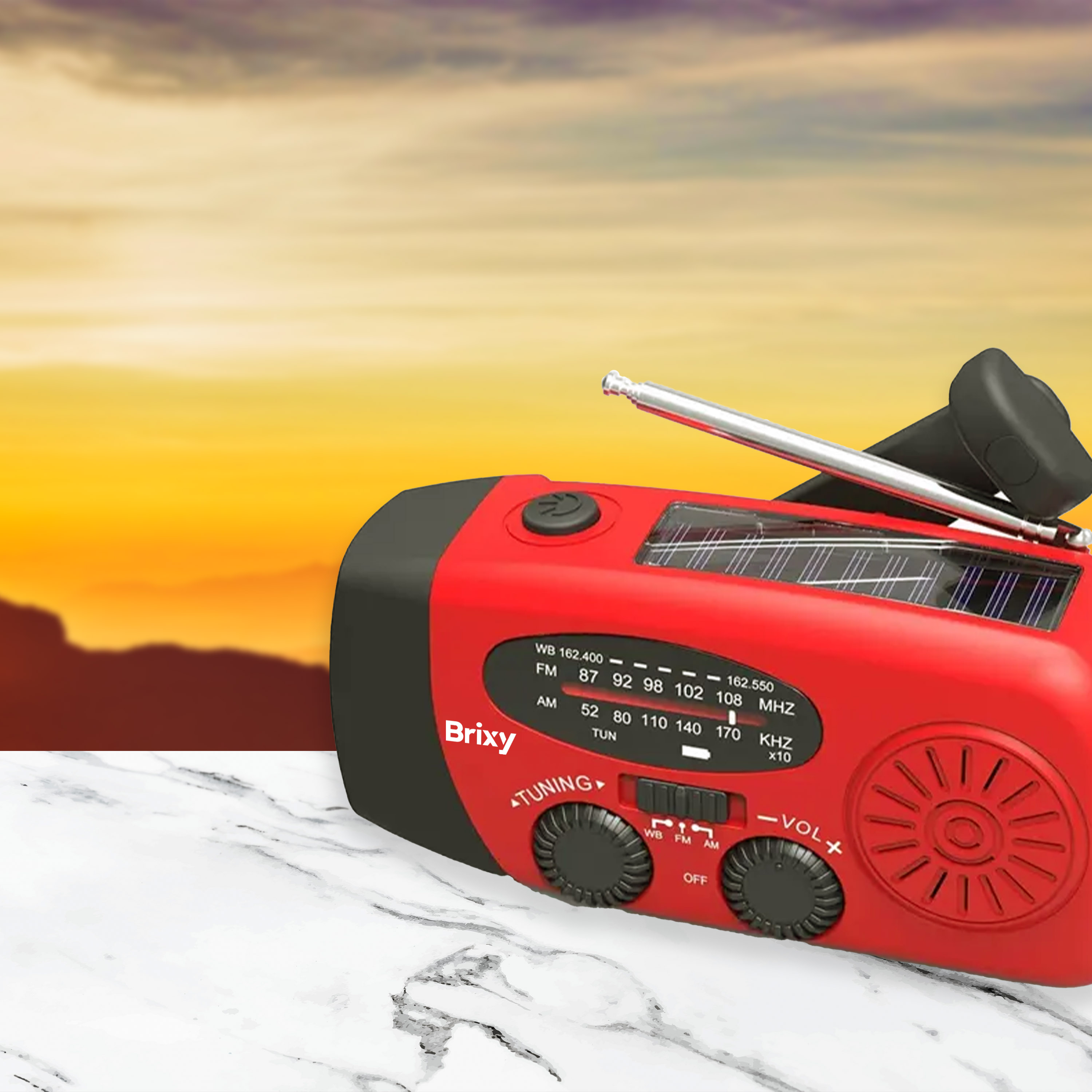 Red and black radio on a marble surface, with a blurred sunset in the background.