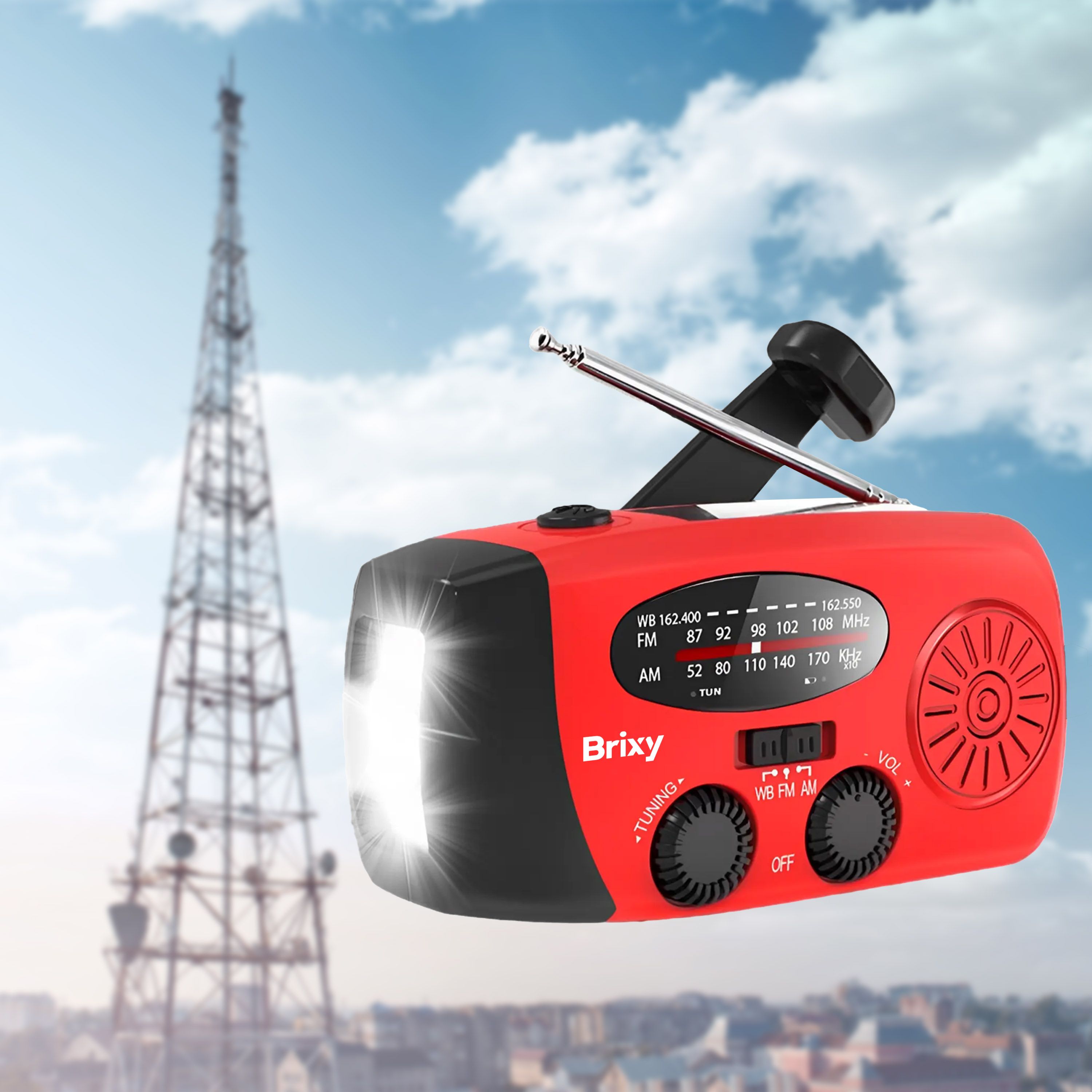 A red and black emergency radio with a light on against a background of a radio tower and sky.