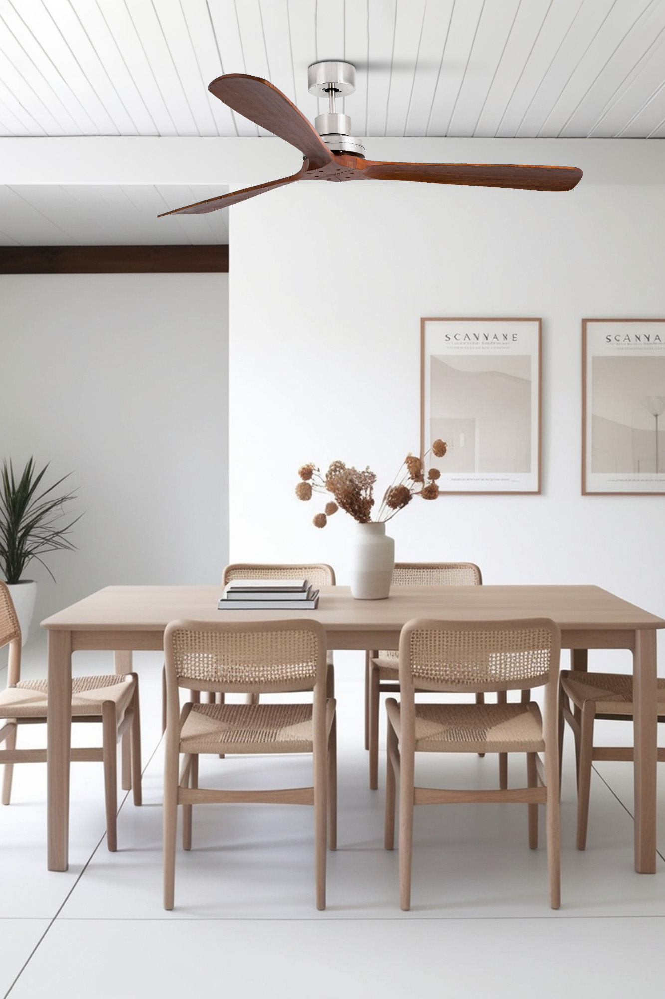 Ein Esszimmer mit Deckenventilator, Tisch und Stühlen. Die Wand hat Kunstwerke. Der Boden ist weiß.