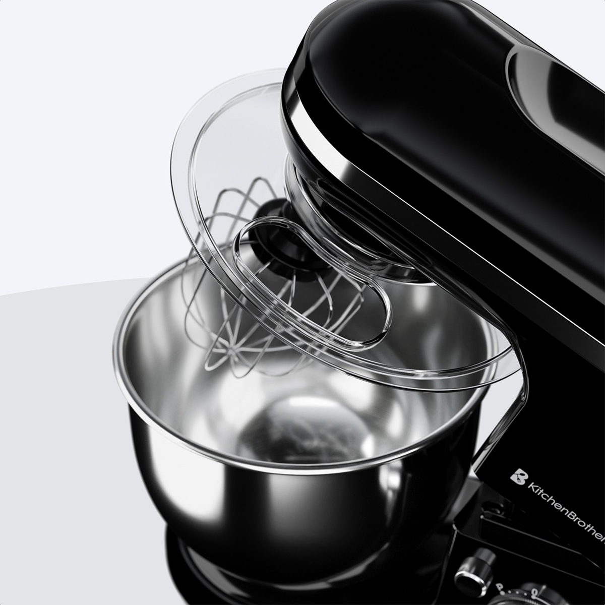 Close-up of black KitchenBrothers stand mixer's bowl and attachments. Clear lid.