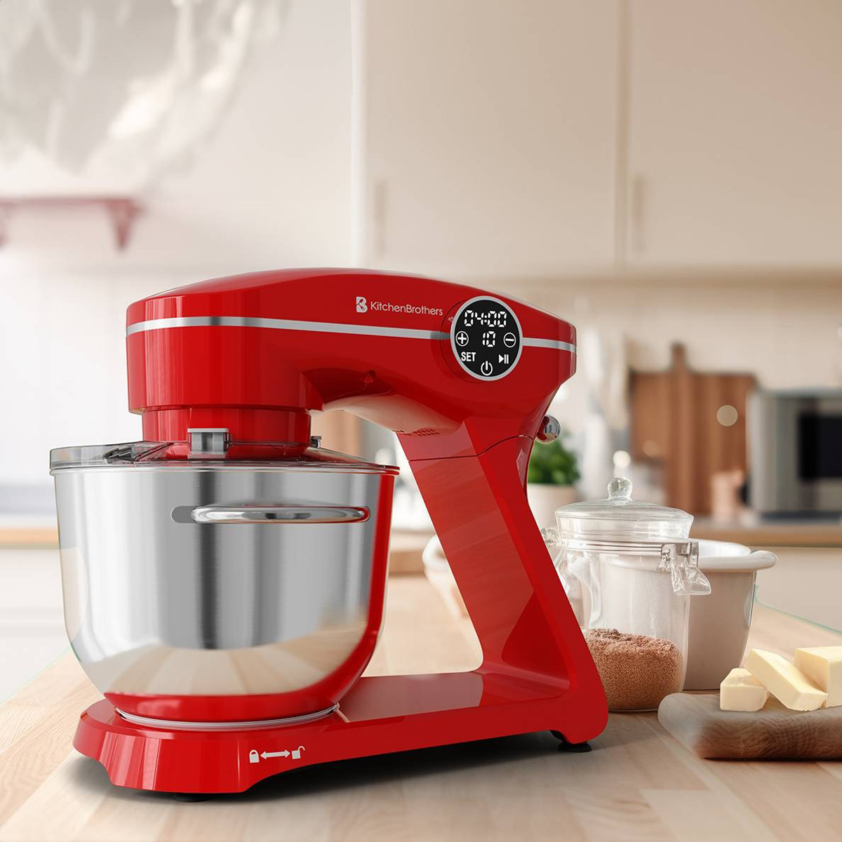 Un mixeur rouge sur une surface en bois, avec du beurre, du sucre et un pot en arrière-plan.