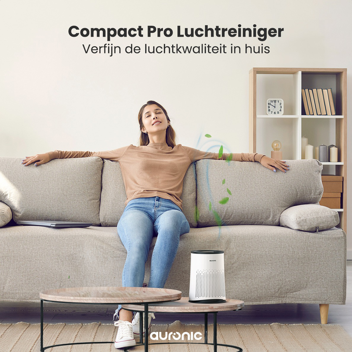 Woman relaxing on a sofa with an air purifier on a table. Text above says 'Compact Pro Air Purifier'.