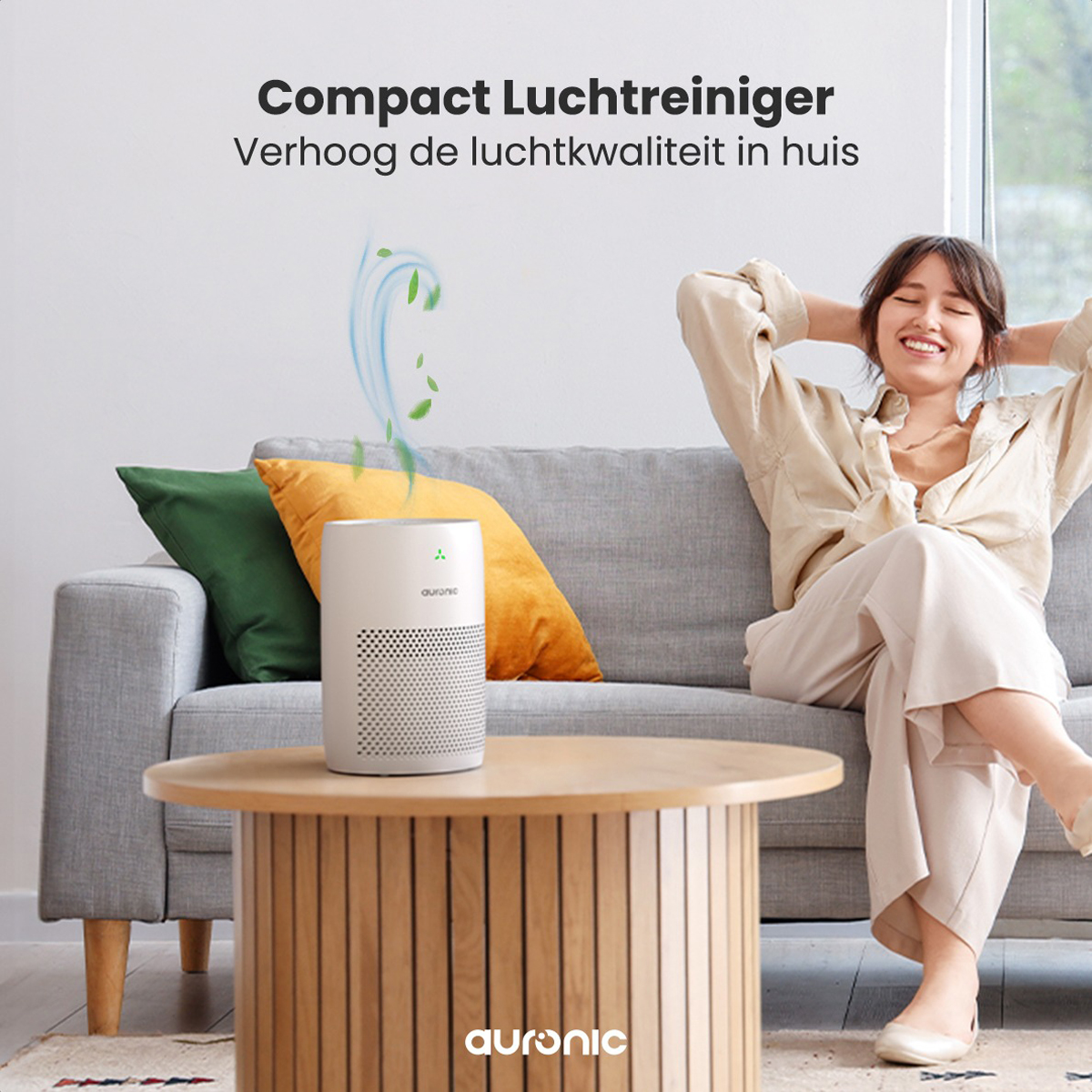 A woman relaxing on a couch with an air purifier on a table.