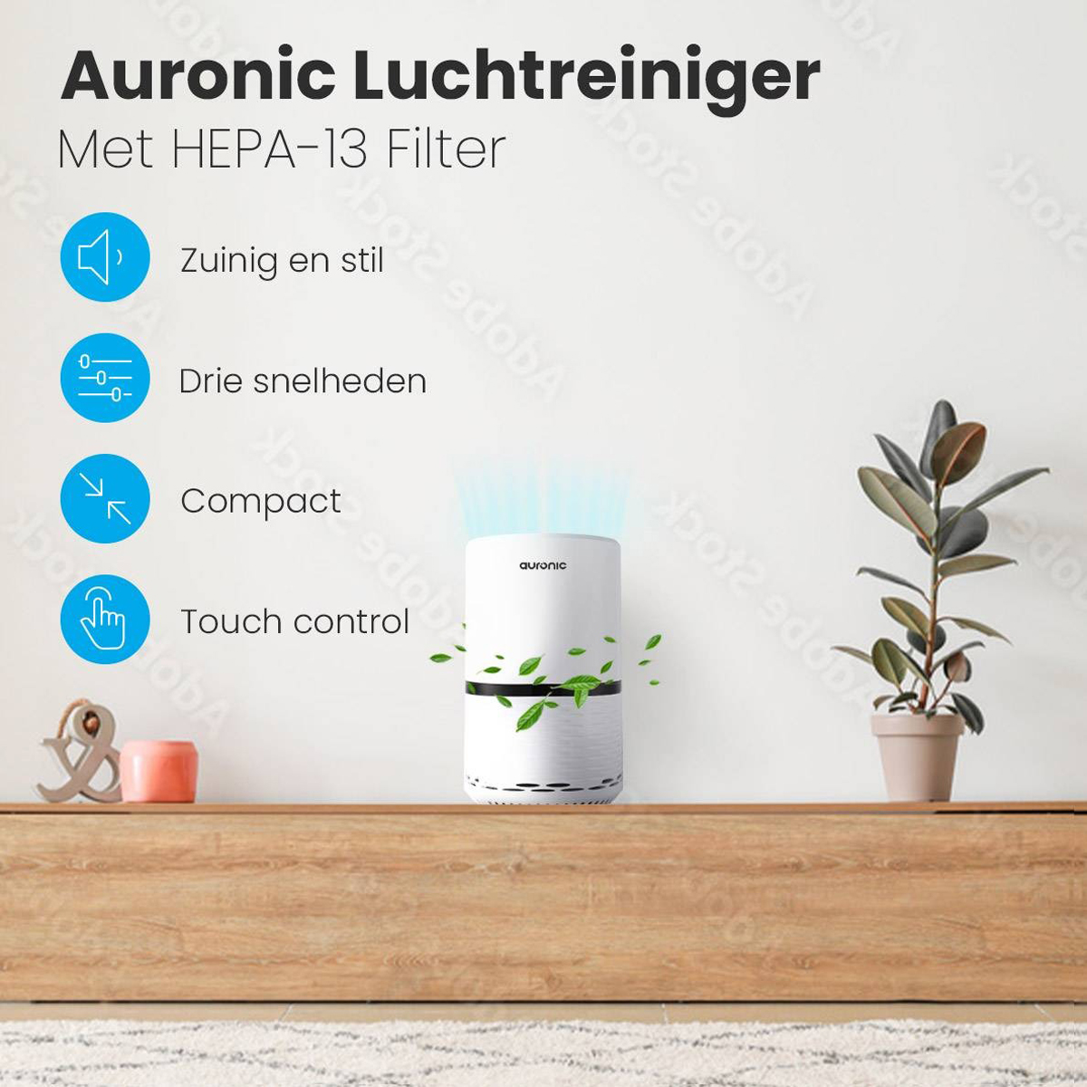 A white air purifier with leaves on a wooden shelf. Plant and decorative items are in the background.