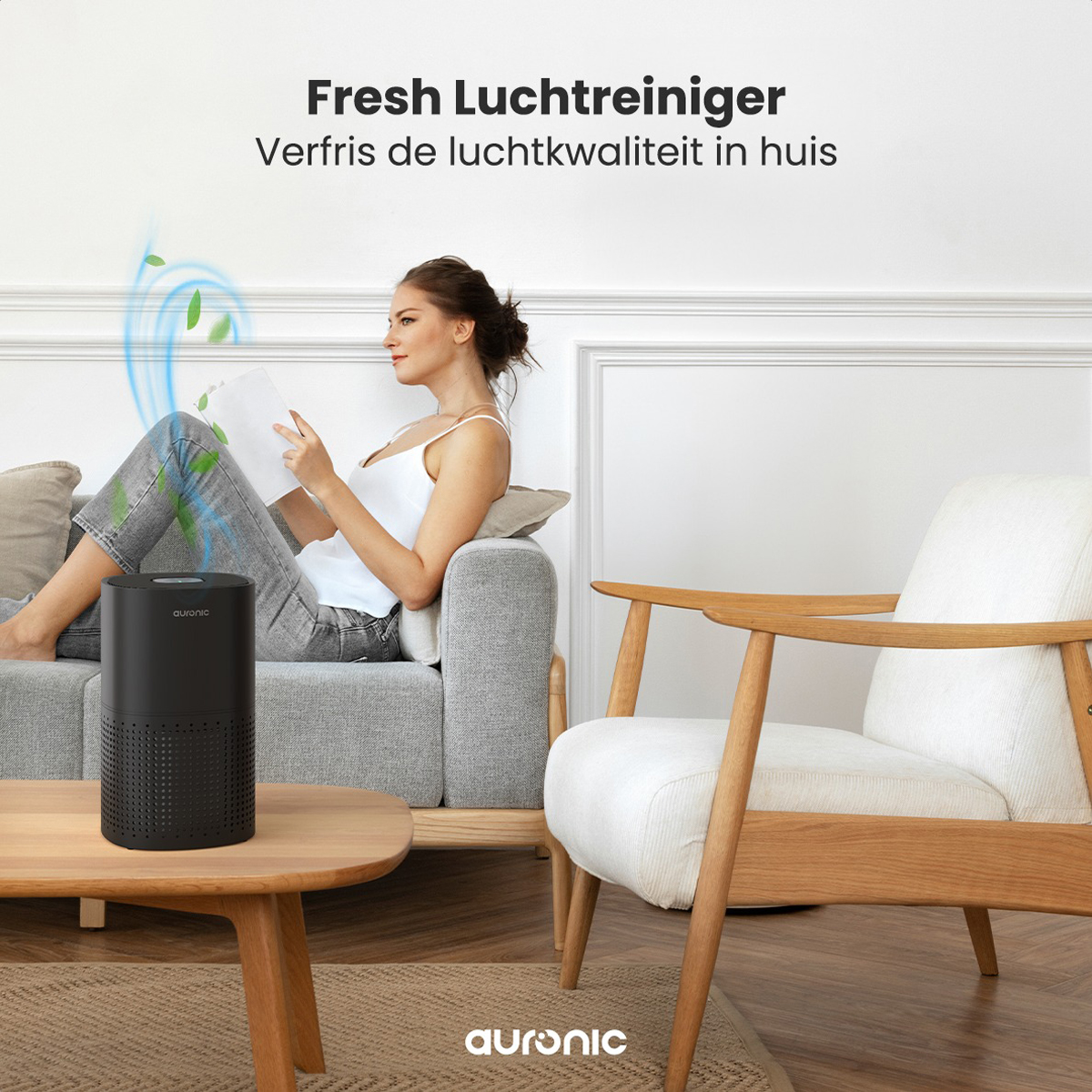 A woman relaxes on a sofa with an air purifier next to a coffee table.