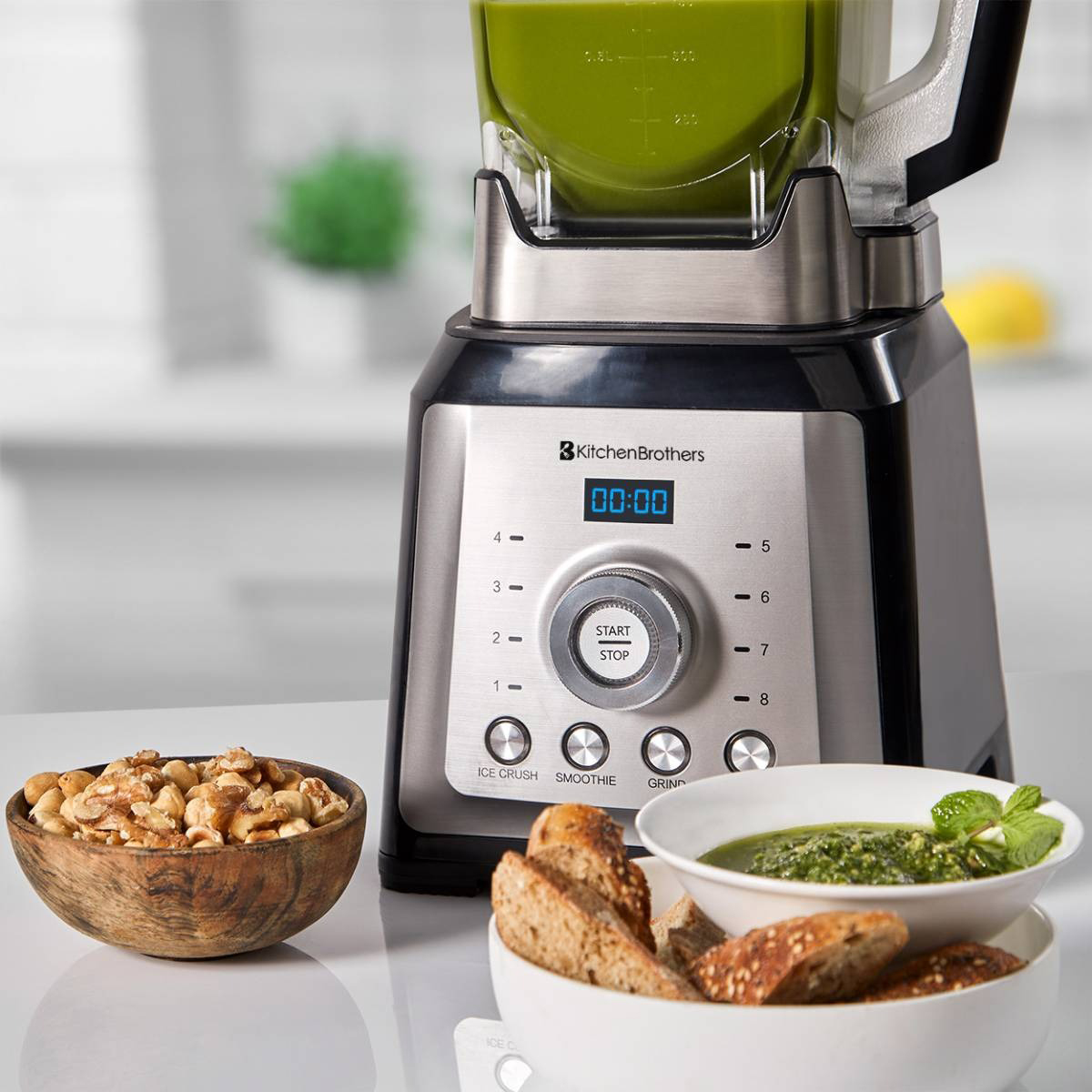 A blender with a green smoothie inside, plus nuts and bread. Text: Blender with a digital display showing time.